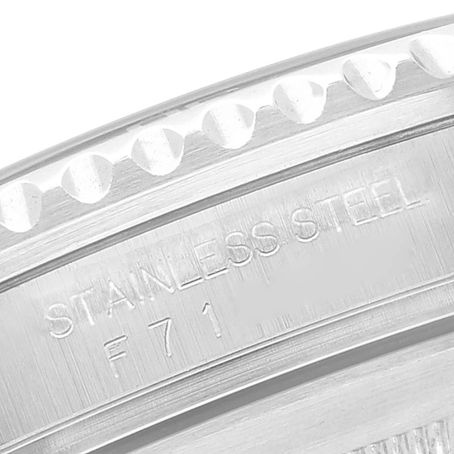 This close-up image of the Rolex Submariner 16610 Men
s Stainless Steel Black Dial 16610 Men
s Stainless Steel Black Dial shows part of the bezel and the engraving on the caseback with "STAINLESS STEEL" and "F71".