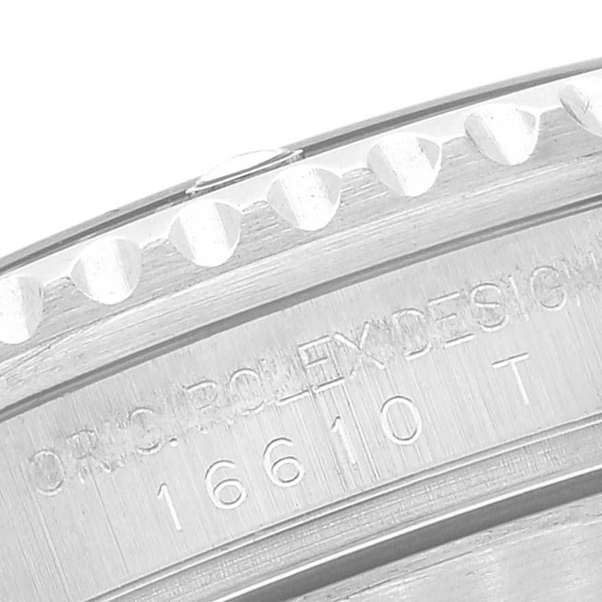 The image shows a close-up of the bezel and case with engraved text of a Rolex Submariner 16610 Men
s Stainless Steel Black Dial 16610 Men
s Stainless Steel Black Dial watch, model number 16610.