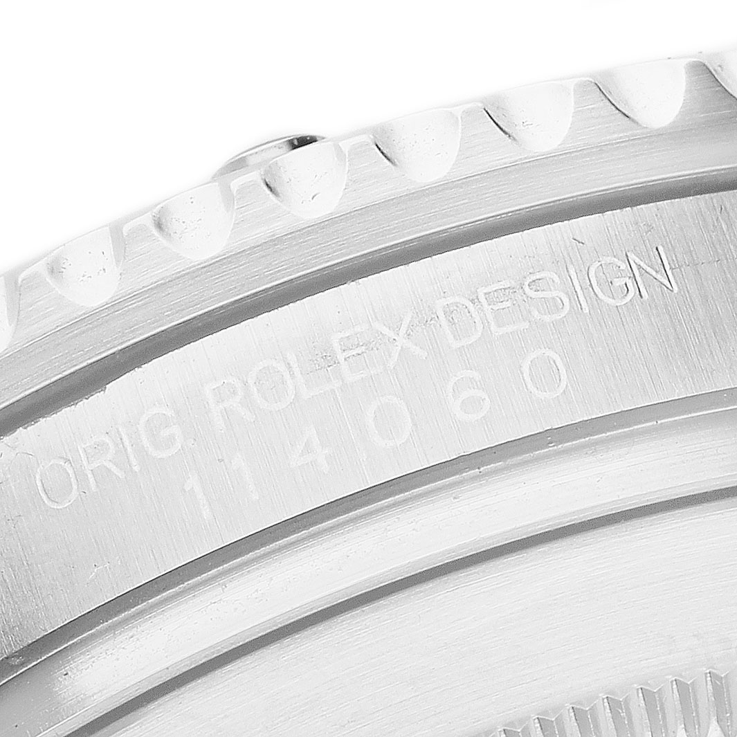 The image shows a close-up of the side case and bezel engraving of a Rolex Submariner 114060 Men's Stainless Steel Black Dial.