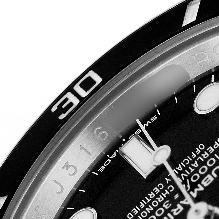 This image shows a close-up of the bezel and a portion of the dial on a Rolex Submariner 114060 Men's Stainless Steel Black Dial watch.