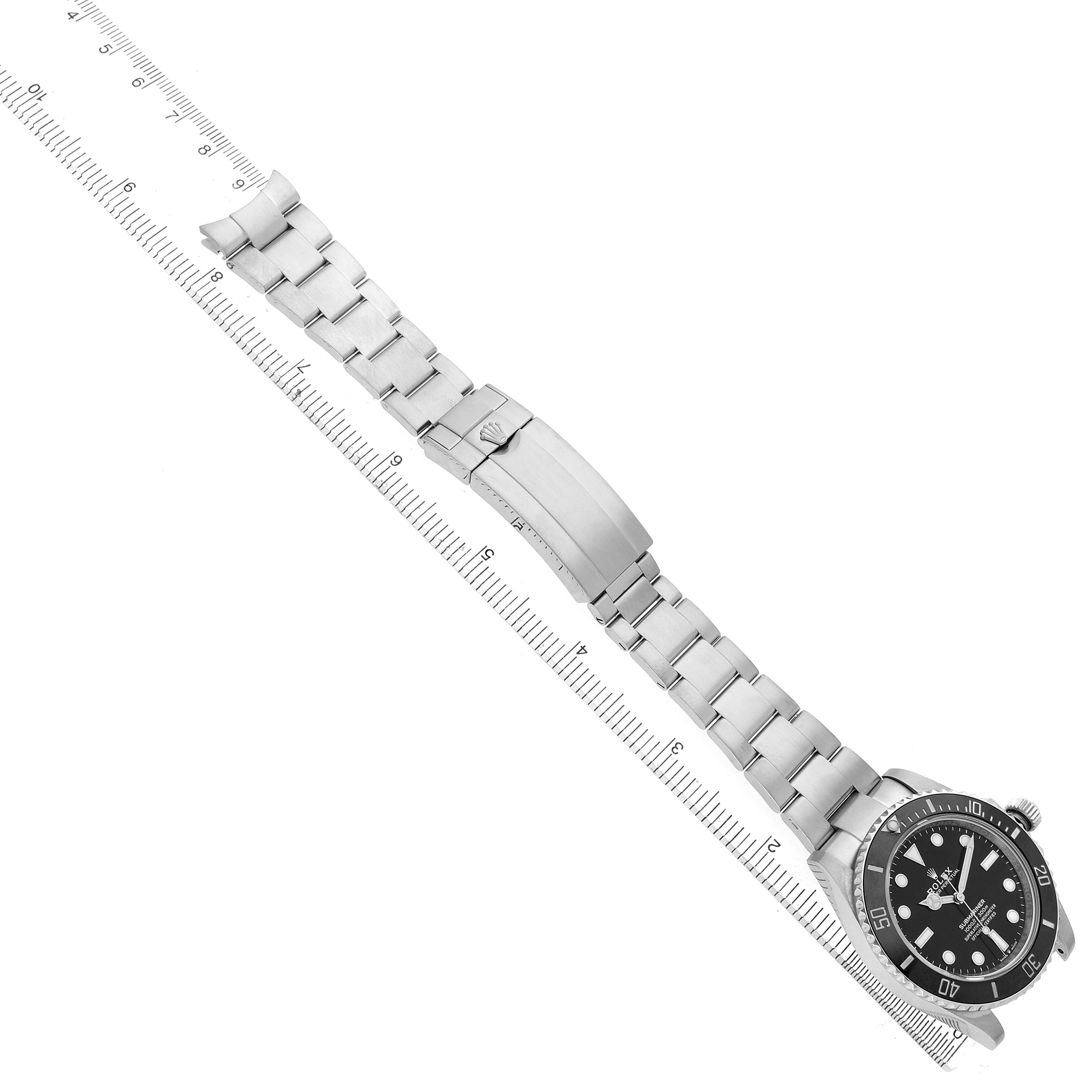 The Rolex Submariner 124060 Men's Stainless Steel Black Dial watch is shown from a top-down angle, displaying the full bracelet and bezel.