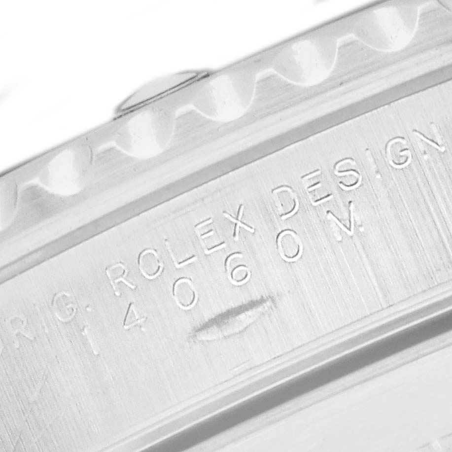 The image shows the side view of a Rolex Submariner 14060 Men
s Stainless Steel Black Dial, highlighting the engraved design details.