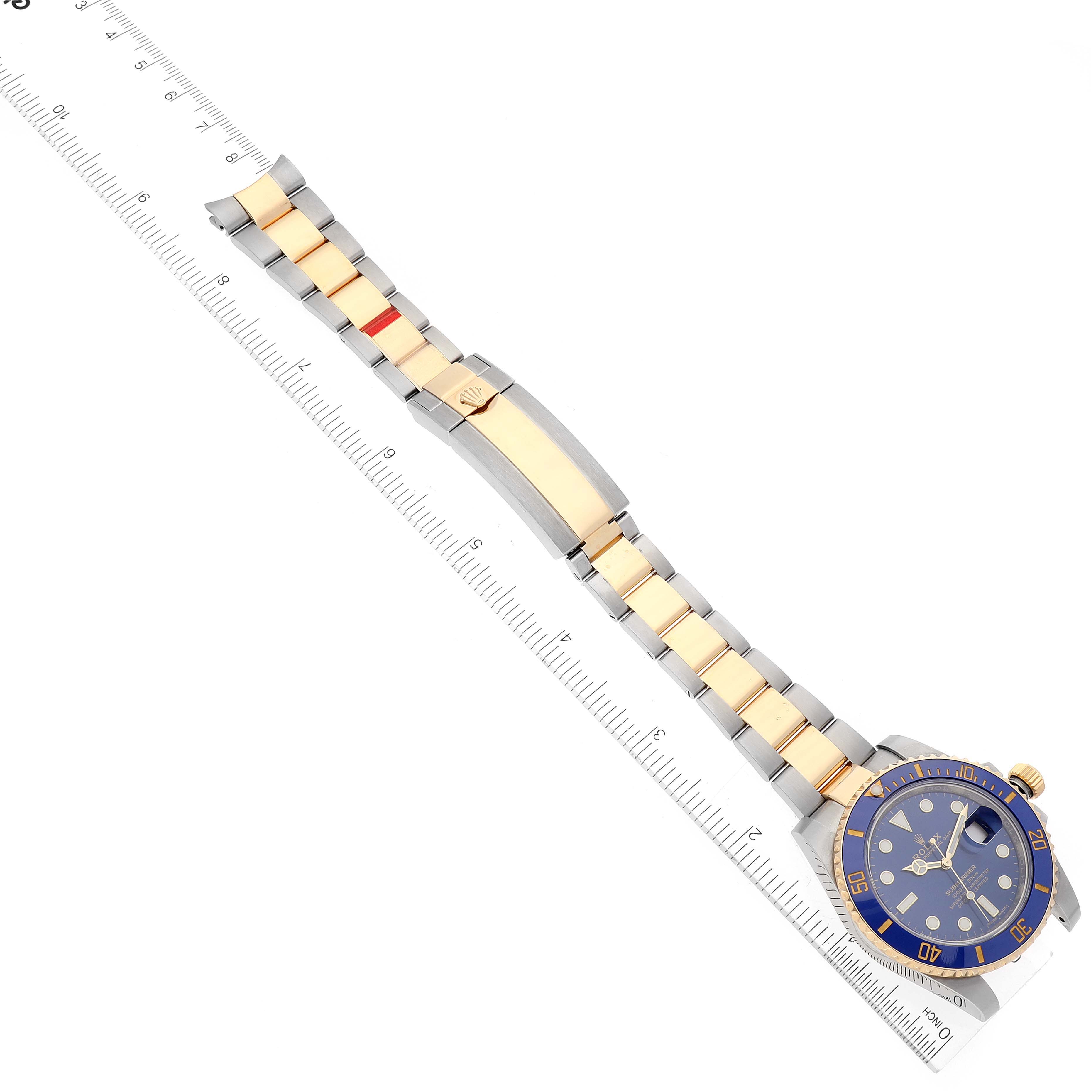 The image shows a Rolex Submariner 116613 Men's Steel and Gold (two tone) Blue Dial 116613 Men's Steel and Gold (two tone) Blue Dial watch, displaying a top view with a focus on the blue dial and two-tone bracelet measured with a ruler.