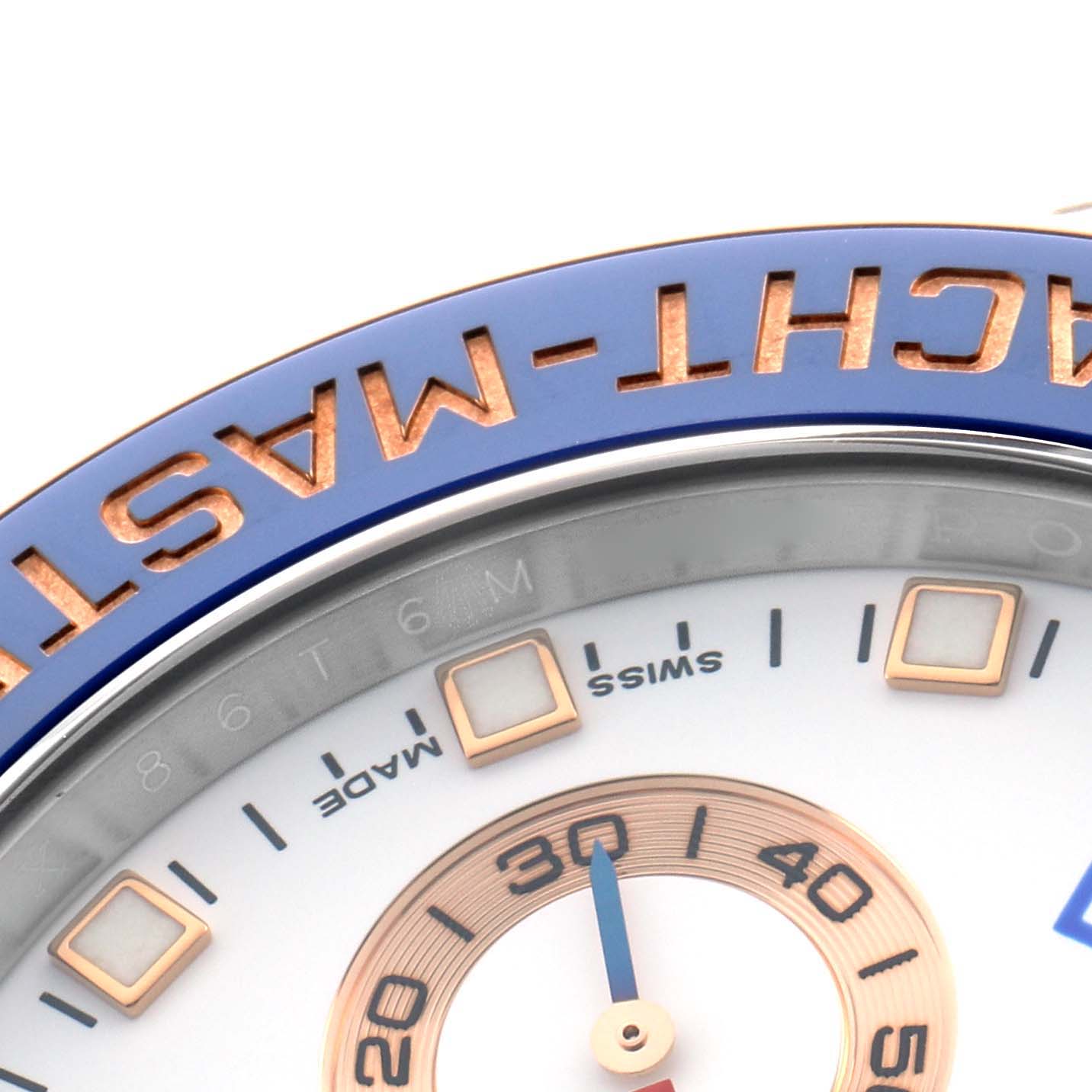 The image shows a close-up of the Rolex Yacht-Master 116681M Men
s Steel and Gold (two tone) White Dial bezel with "YACHT-MASTER" engraved in gold on a blue background.