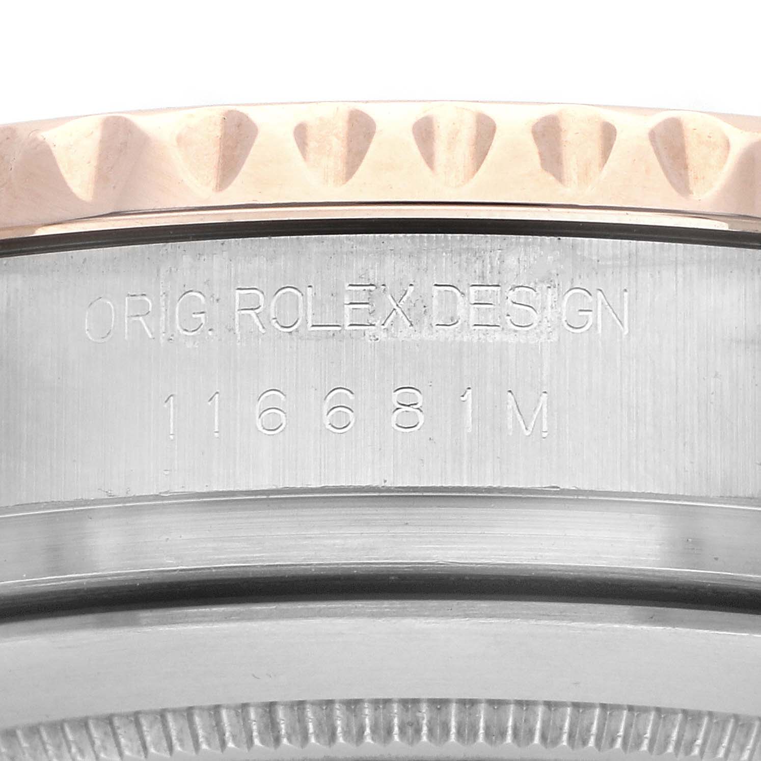 The image shows a close-up of the Rolex Yacht-Master 116681M Men
s Steel and Gold (two tone) White Dial
s side, highlighting the engraved model number and "ORIG ROLEX DESIGN."