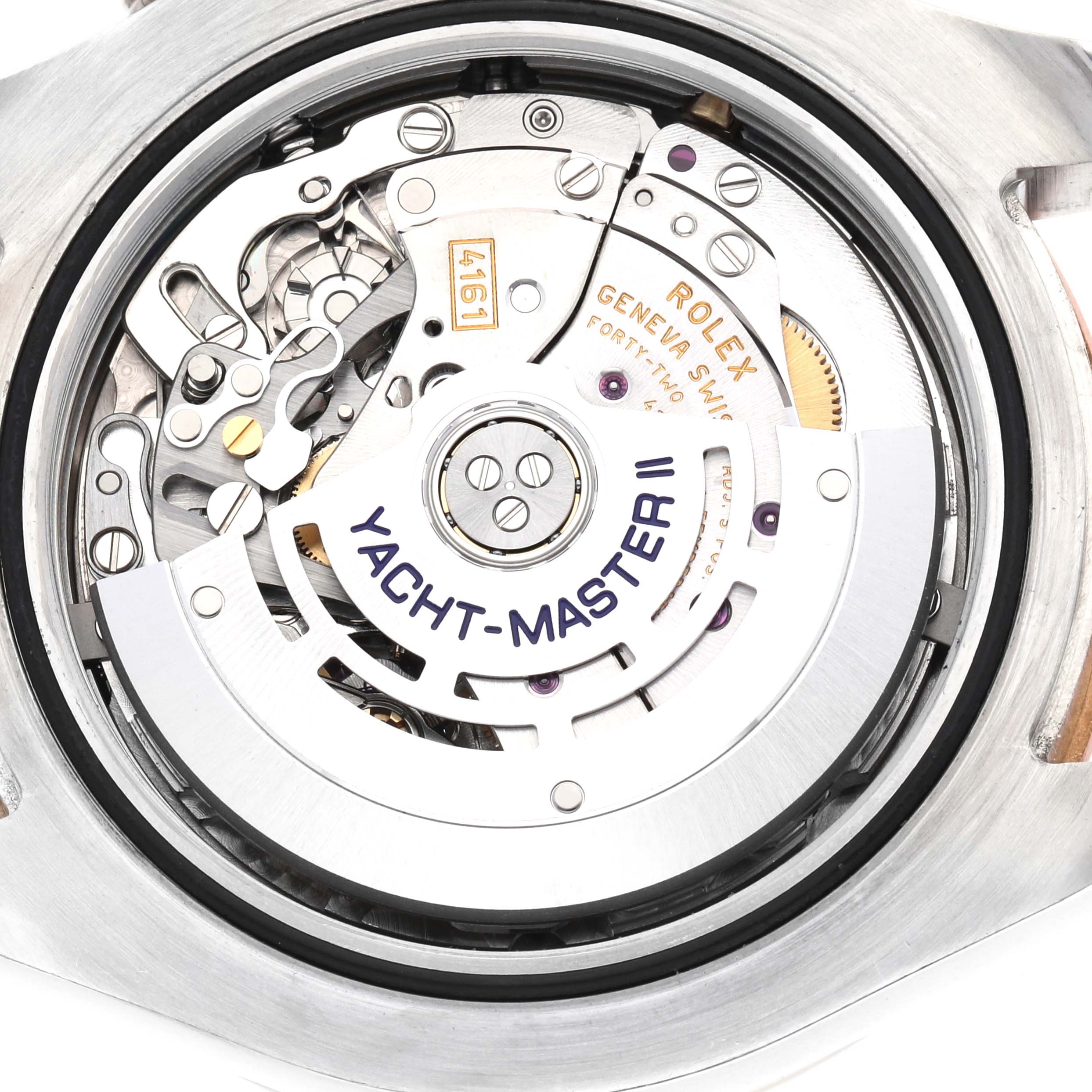 The image shows the movement and internal mechanics of a Rolex Yacht-Master 116681M Men
s Steel and Gold (two tone) White Dial II from a rear view angle.