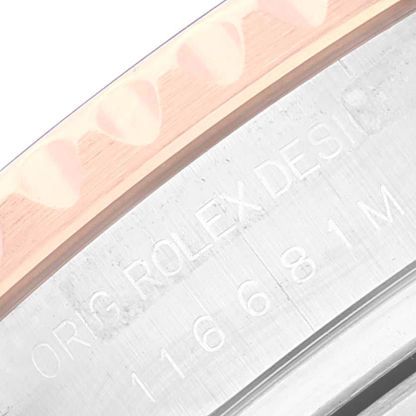 The image shows a close-up angle of the engraving and bezel of a Rolex Yacht-Master 116681 Men
s Steel and Gold (two tone) White Dial 116681 Men
s Steel and Gold (two tone) White Dial watch.