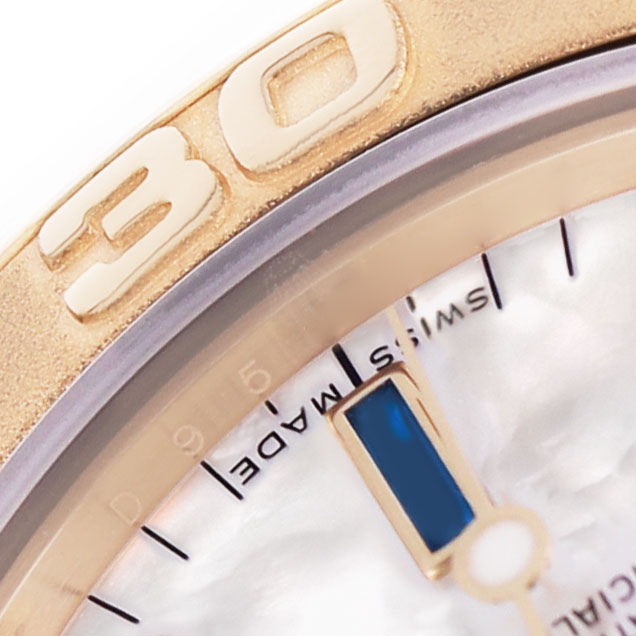 The image shows a close-up of the Rolex Yacht-Master 168628 Women's Yellow Gold Mother of Pearl Dial's 30-minute bezel and part of the dial.