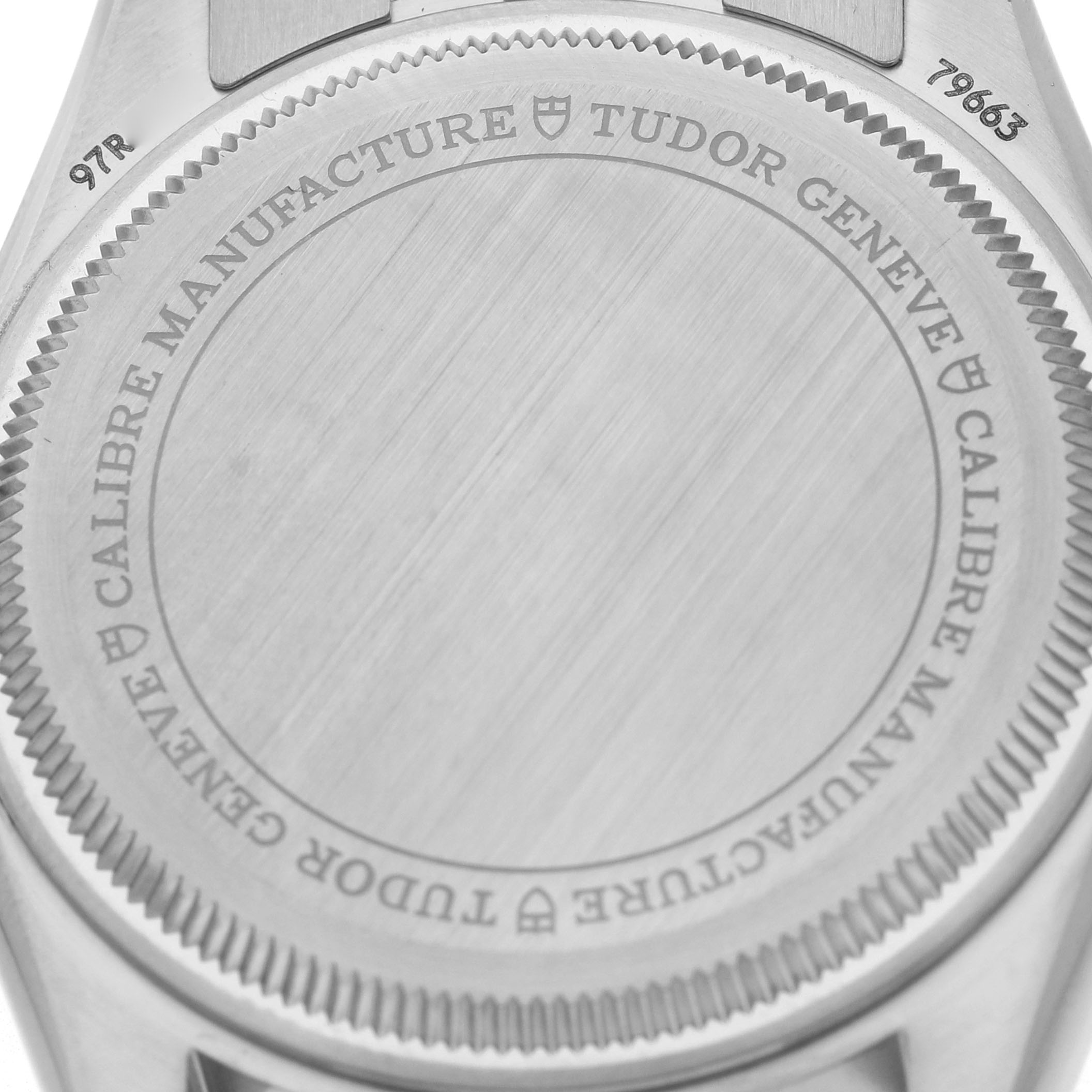 The image shows the case back of a Tudor Heritage Black Bay 79663 Men's Steel and Gold (two tone) Black Dial watch, highlighting the engraved details and brushed finish.