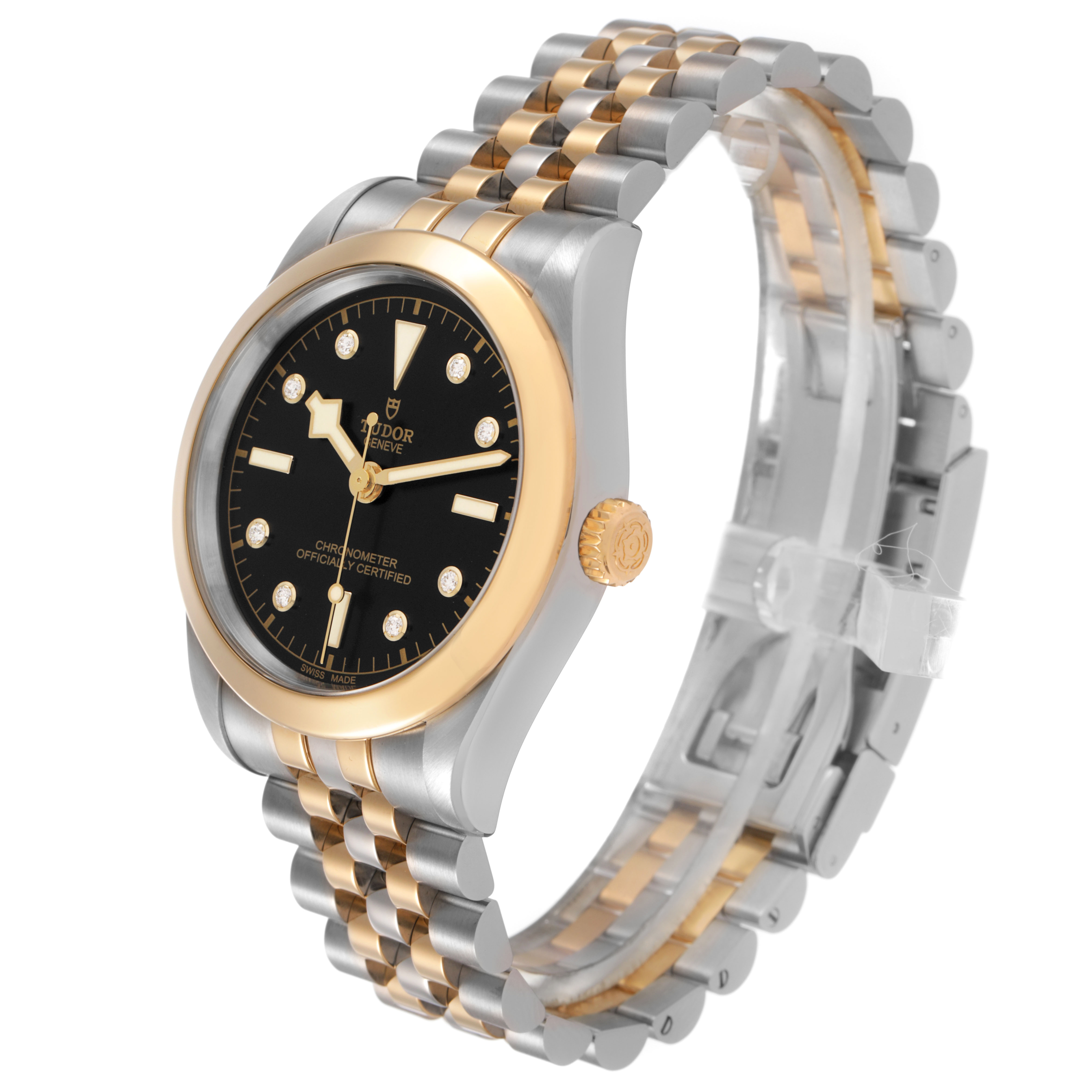 The Tudor Heritage Black Bay 79663 Men's Steel and Gold (two tone) Black Dial watch is shown at a three-quarter angle, highlighting its two-tone bracelet and round black dial.