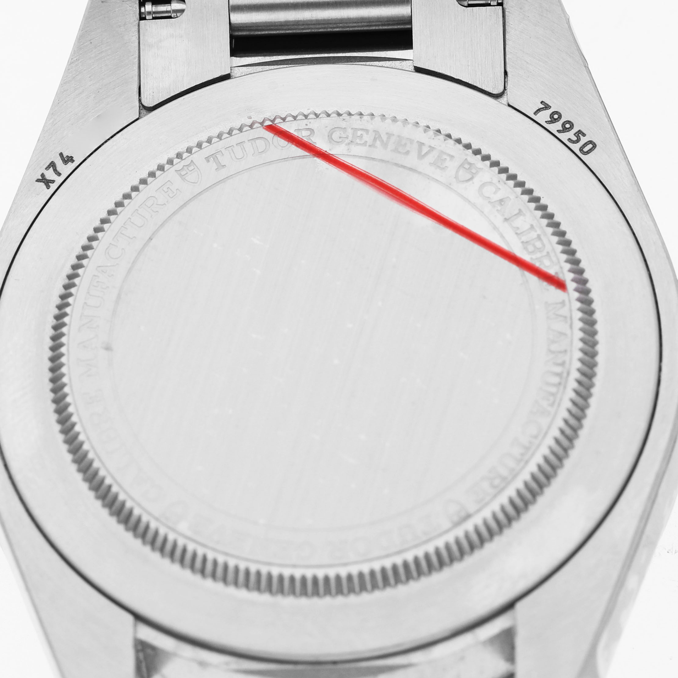 The image shows the back case of a Tudor Heritage Ranger 79950 Men's Stainless Steel Black Dial watch, highlighting its engraved details.