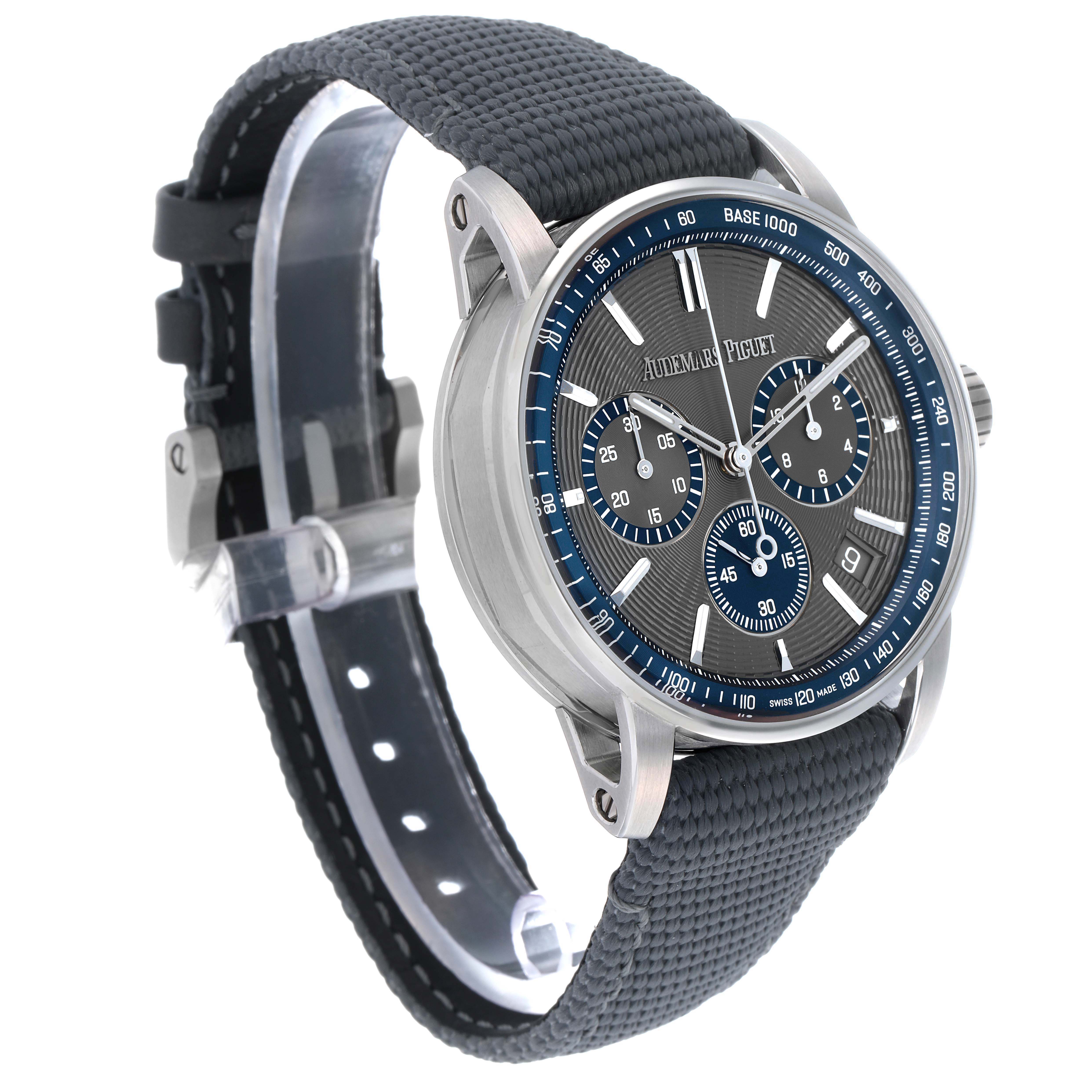 The Audemars Piguet Jules 26393ST Men's Stainless Steel Grey Dial watch is shown at a three-quarter angle, highlighting the face, blue accents, and textured strap.