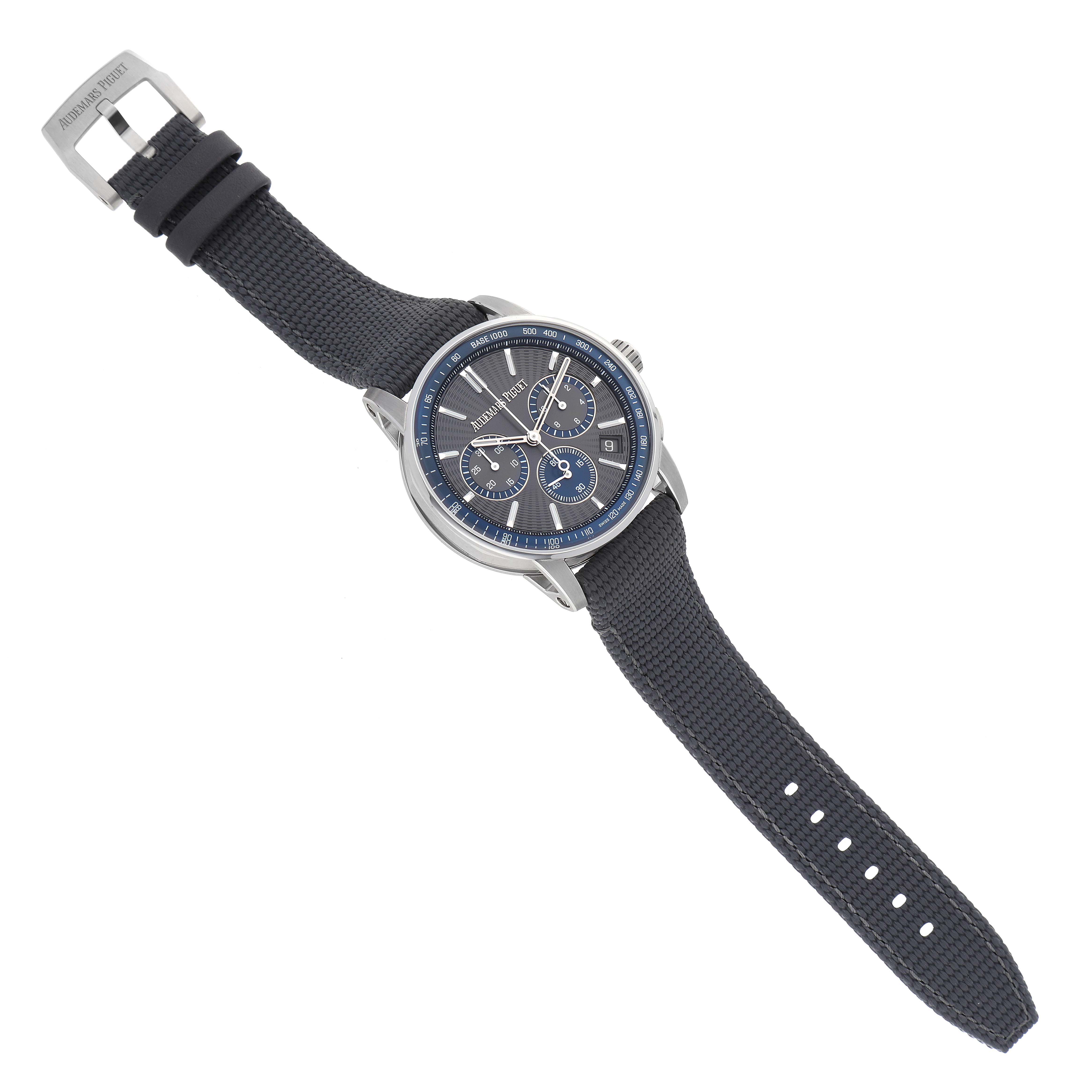 The watch, a Jules model by Audemars Piguet, is shown from a top angle, highlighting the face, strap, and buckle.