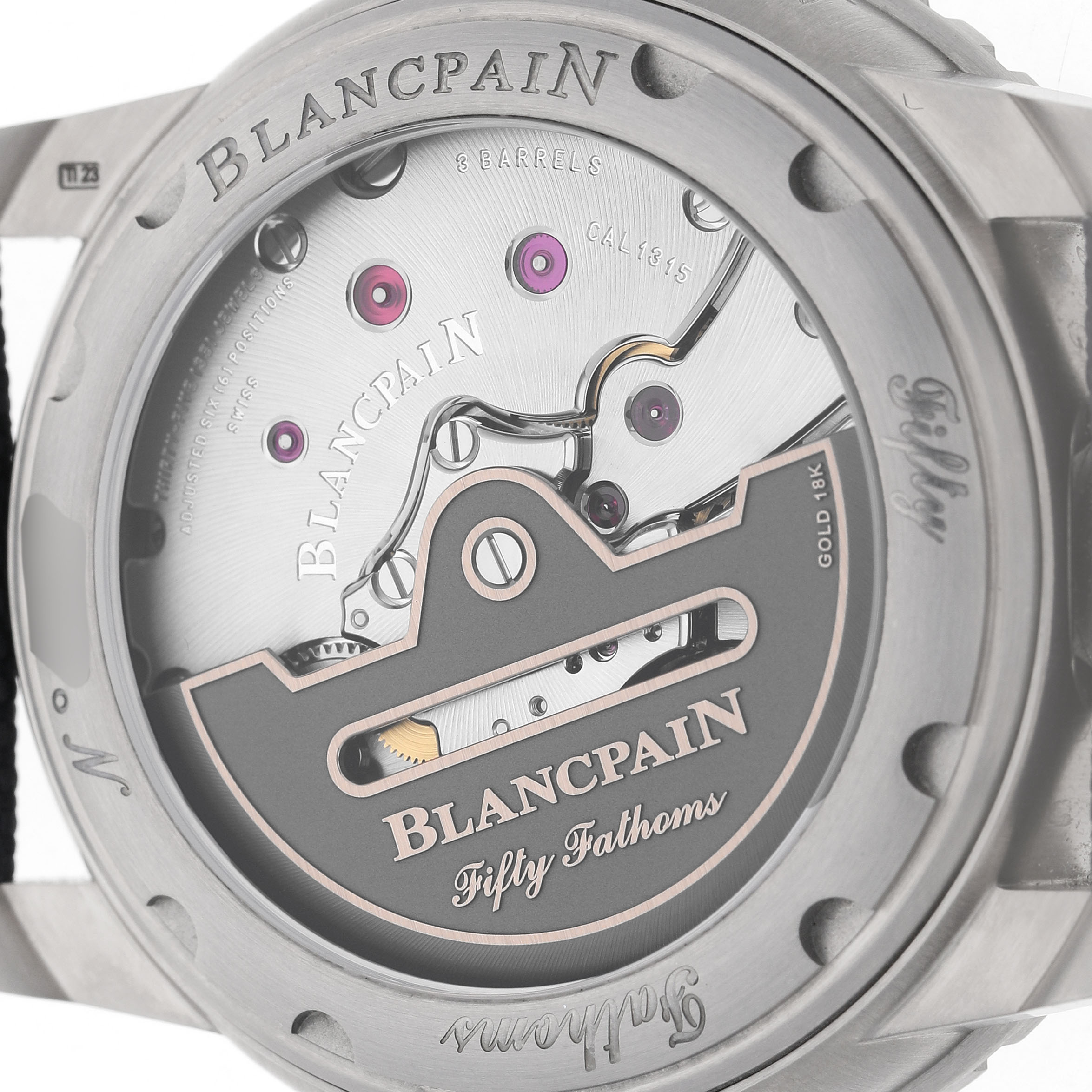 The image shows the back view of a Blancpain Fifty Fathoms 5010-12B40-O52A Men's Titanium Blue Dial watch, highlighting its intricate movement and engravings.