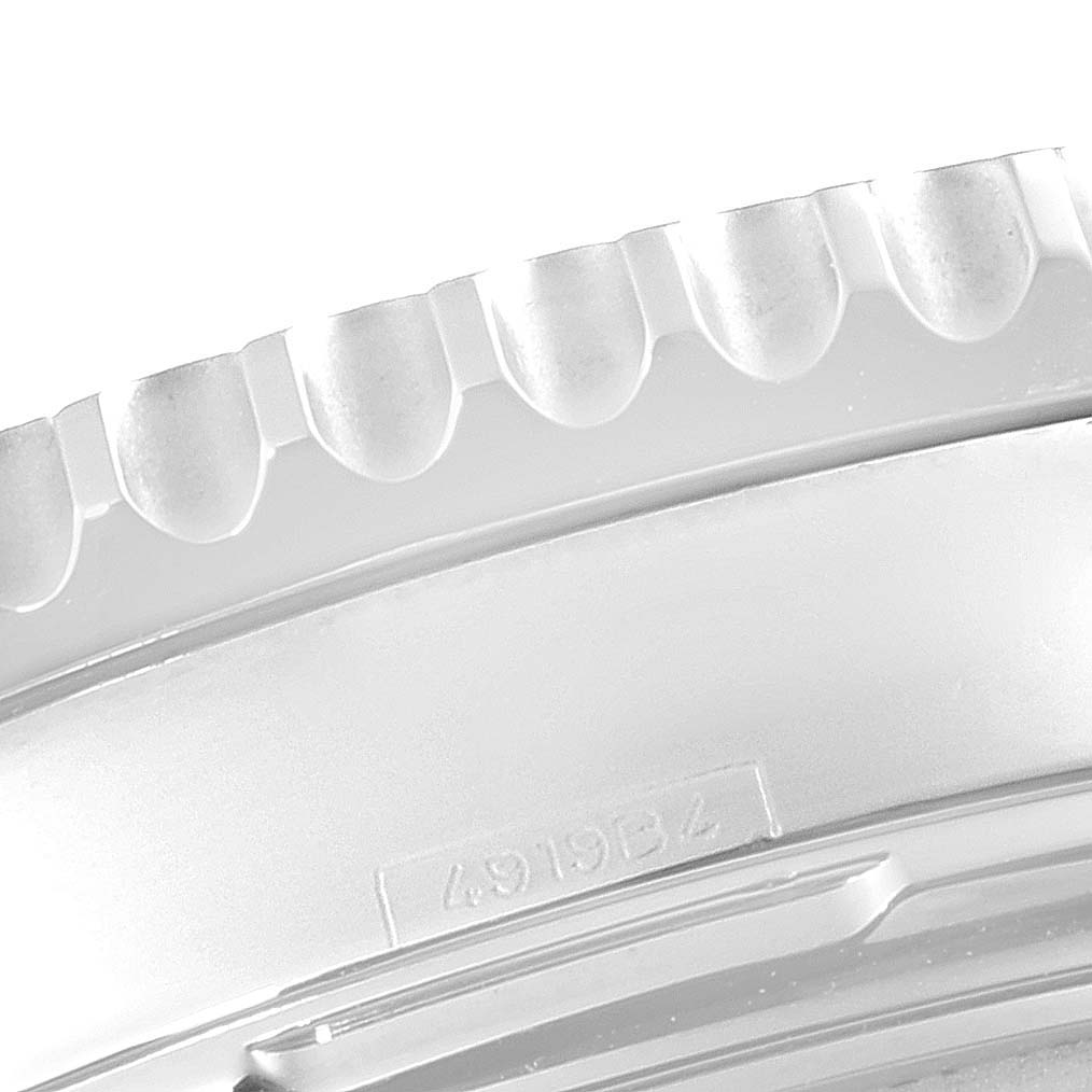 This image shows a close-up of the bezel rim and case edge of a Breitling Navitimer AB0121 Men
s Stainless Steel Black Dial AB0121 Men
s Stainless Steel Black Dial watch.