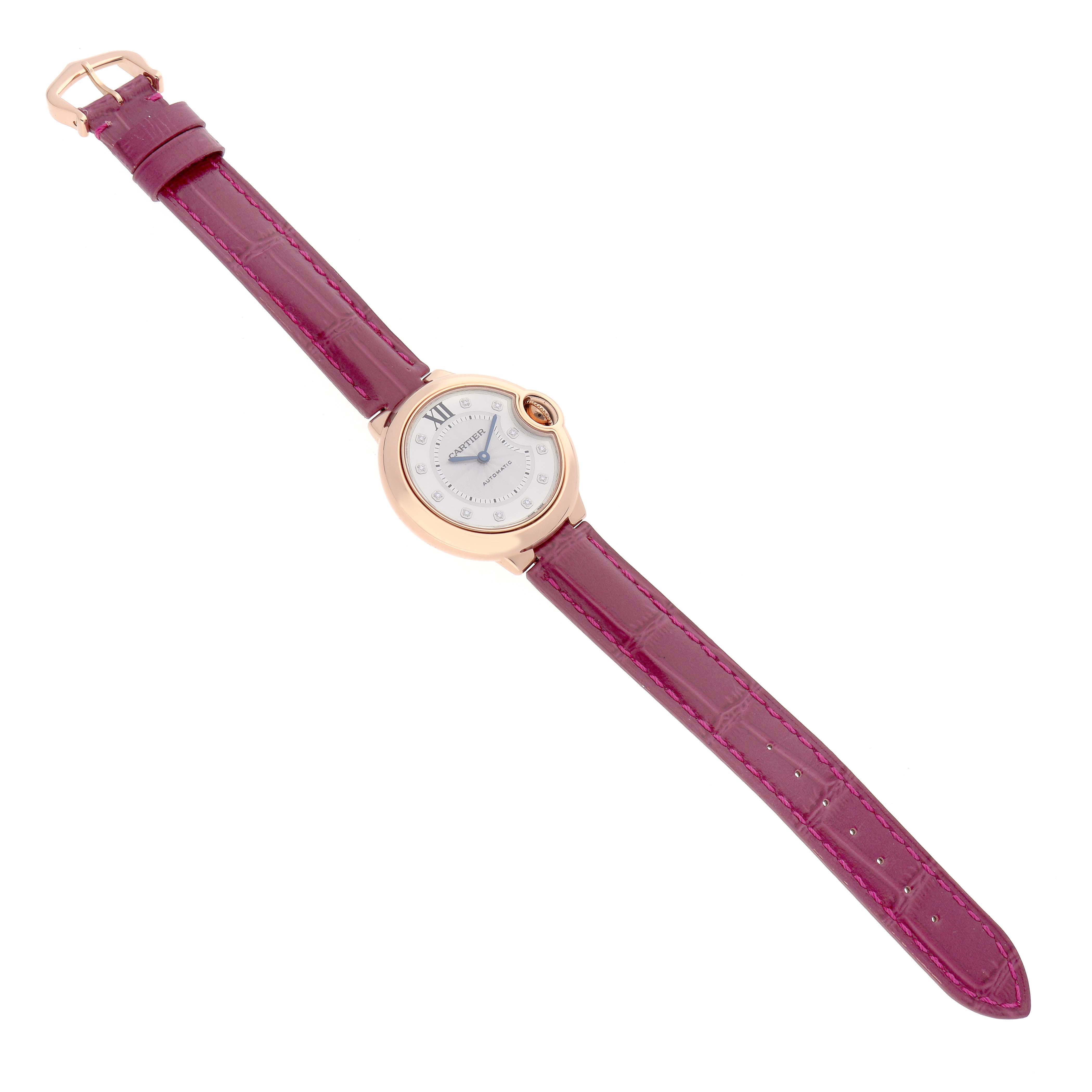 The Cartier Ballon Bleu WE902063 Women's Rose Gold Silver Dial watch is shown from a top-down angle, displaying the full face and purple strap.