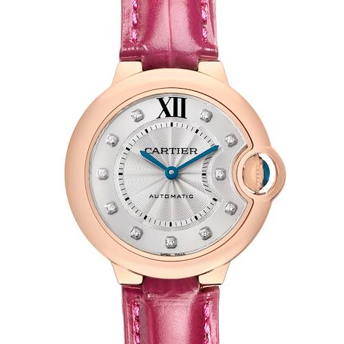 This Cartier Ballon Bleu WE902063 Women's Rose Gold Silver Dial watch is shown from the front, displaying its pink strap, rose gold case, and blue hands.