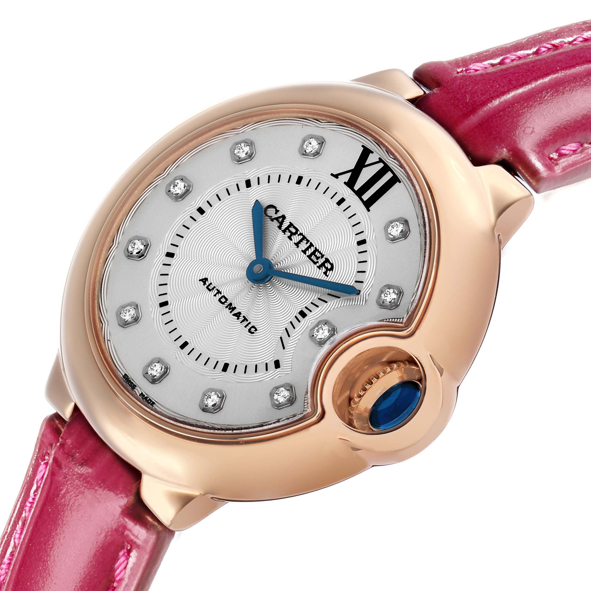 The Cartier Ballon Bleu WE902063 Women's Rose Gold Silver Dial watch is shown at a tilted angle, highlighting the dial, crown with blue cabochon, and pink strap.