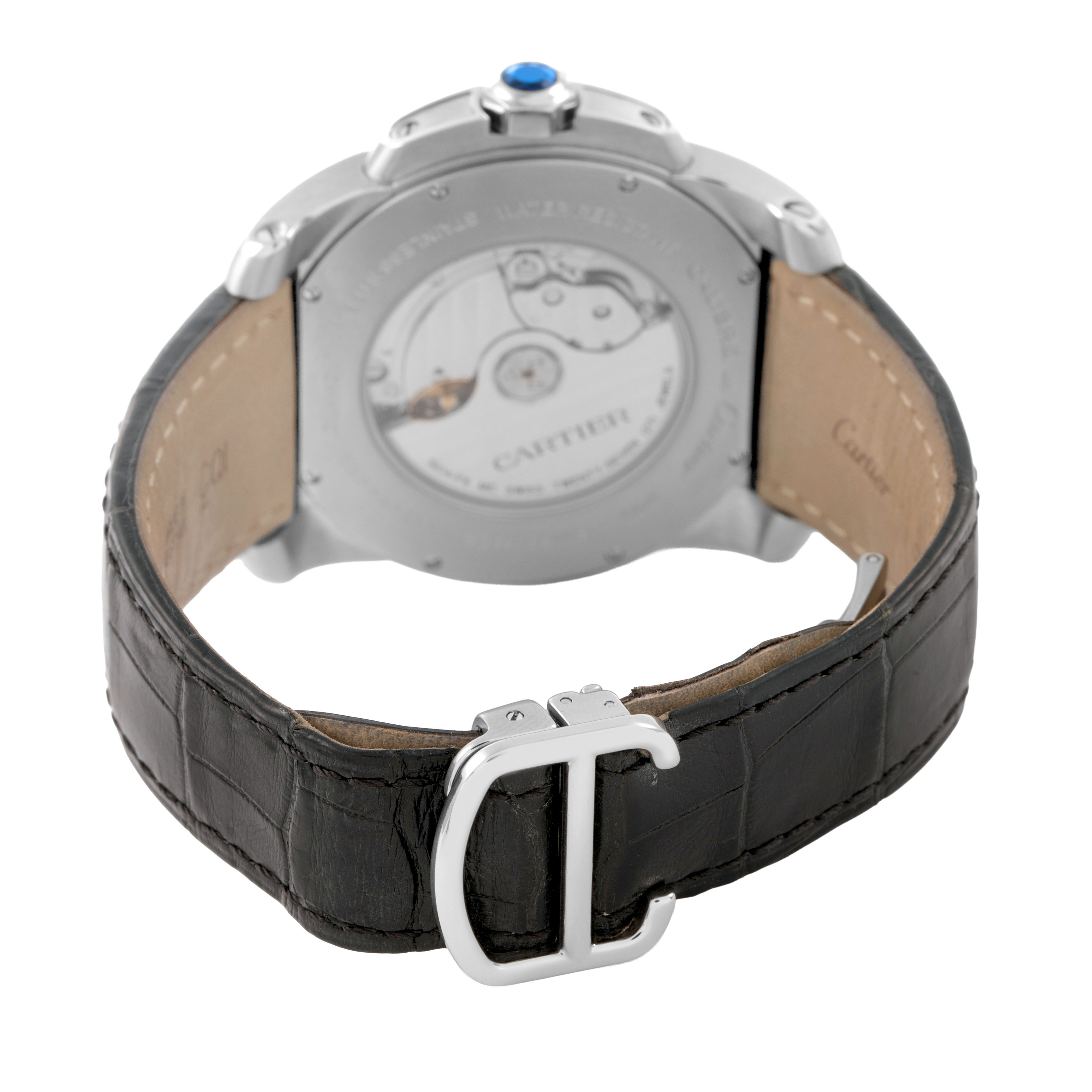 The image shows the back of the Calibre de Cartier watch, highlighting its case back, movement, leather strap, and clasp.