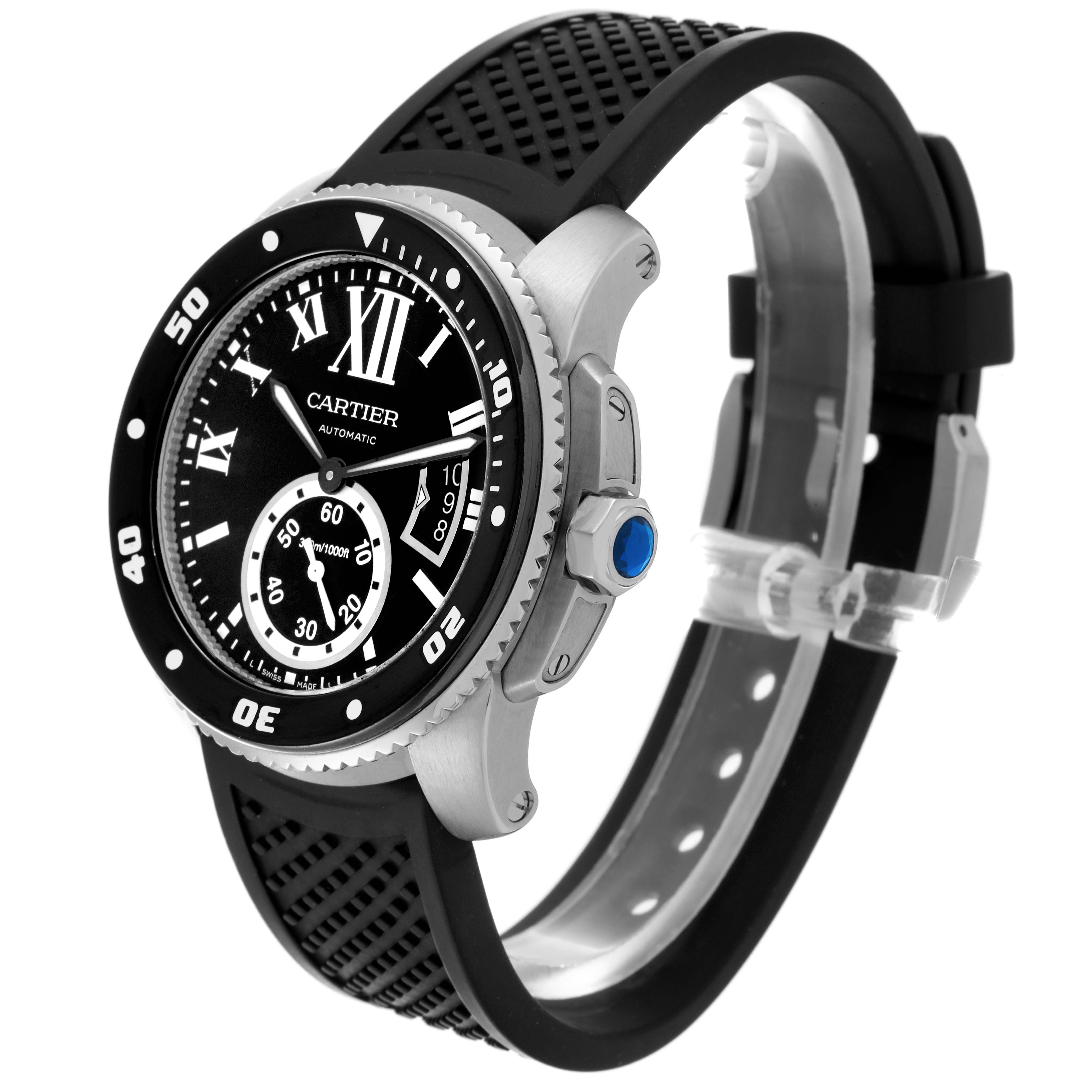 The Calibre de Cartier watch is shown in a three-quarter angle, highlighting the face, bezel, crown, and rubber strap.