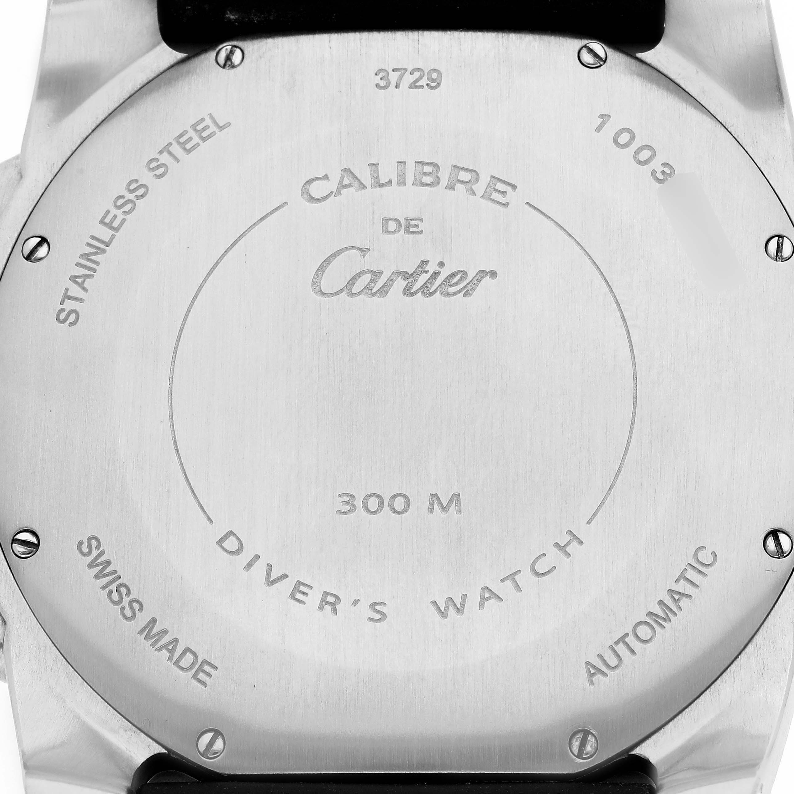 The image shows the back case of the Calibre de Cartier watch displaying engravings and model details.