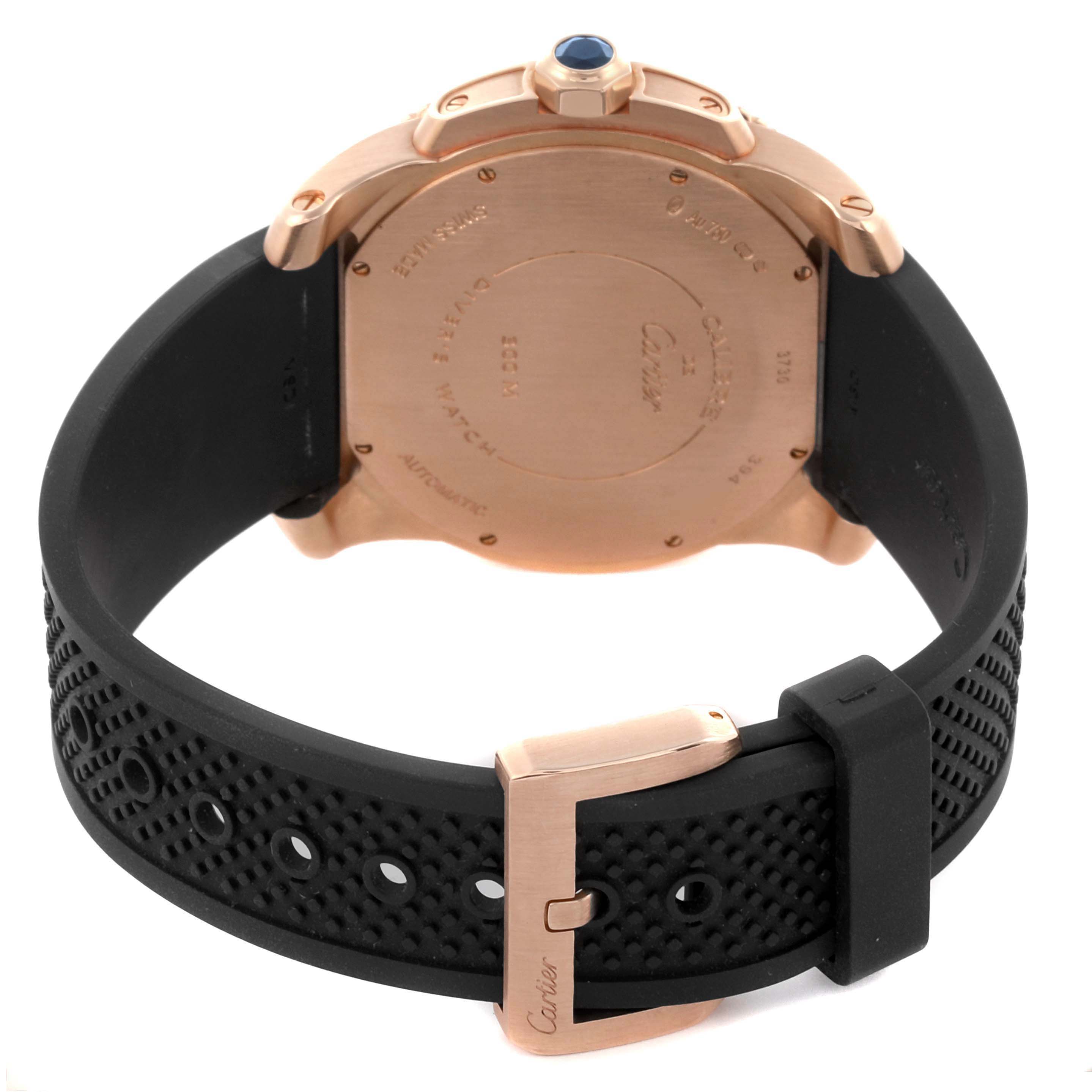 The Calibre de Cartier watch is shown from the back, highlighting the case back, buckle, and rubber strap.