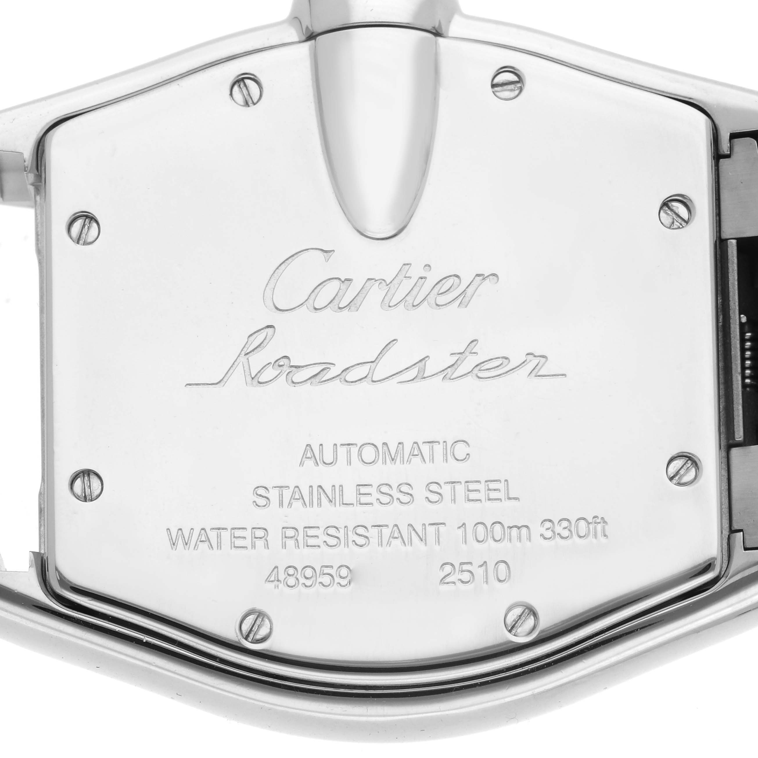 The image shows the back case of a Cartier Roadster W62025V3 Men's Stainless Steel Silver Dial, displaying its inscriptions and screws.