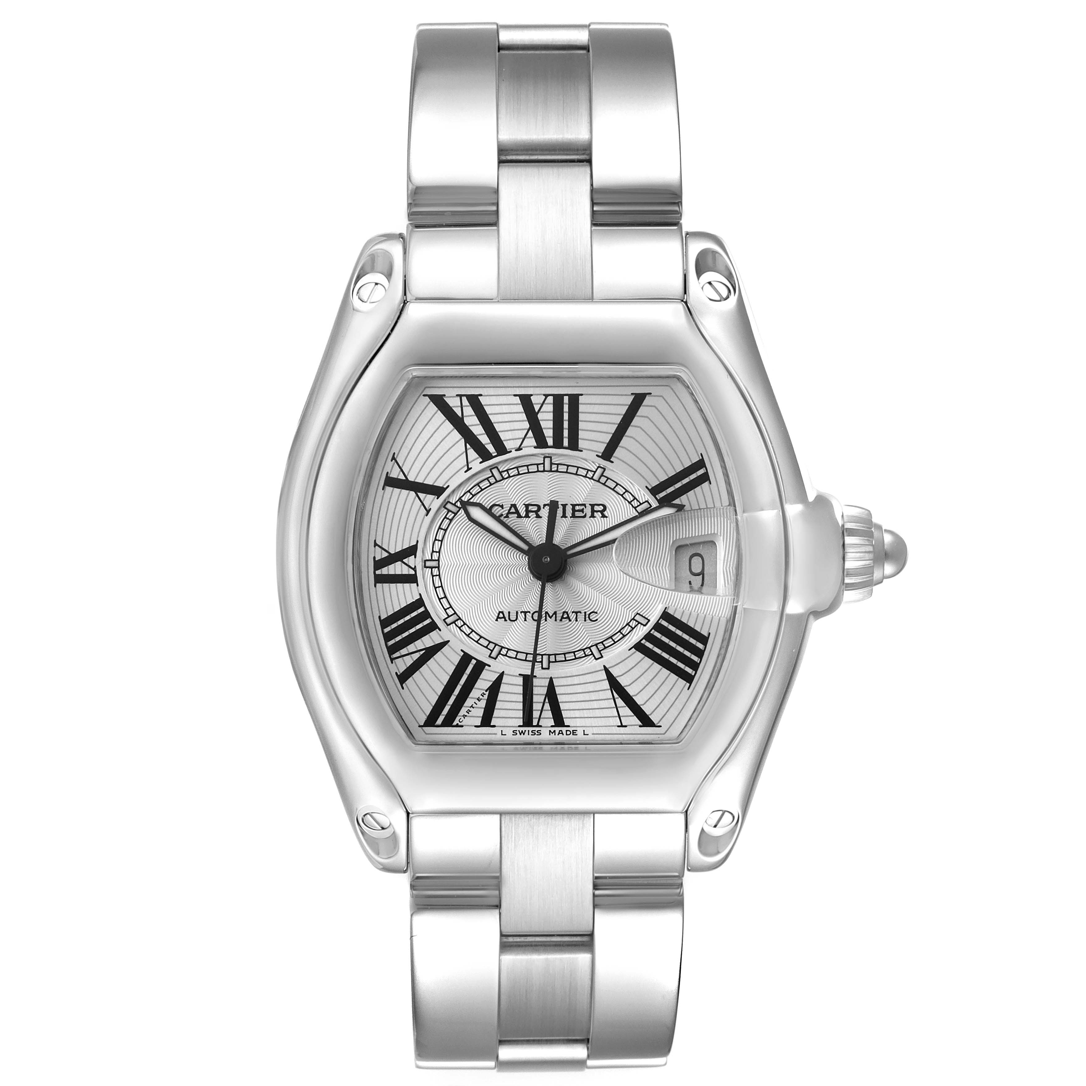 The Cartier Roadster W62025V3 Men's Stainless Steel Silver Dial watch is shown from a top-down angle, displaying the face, Roman numerals, bezel, date window, and bracelet.