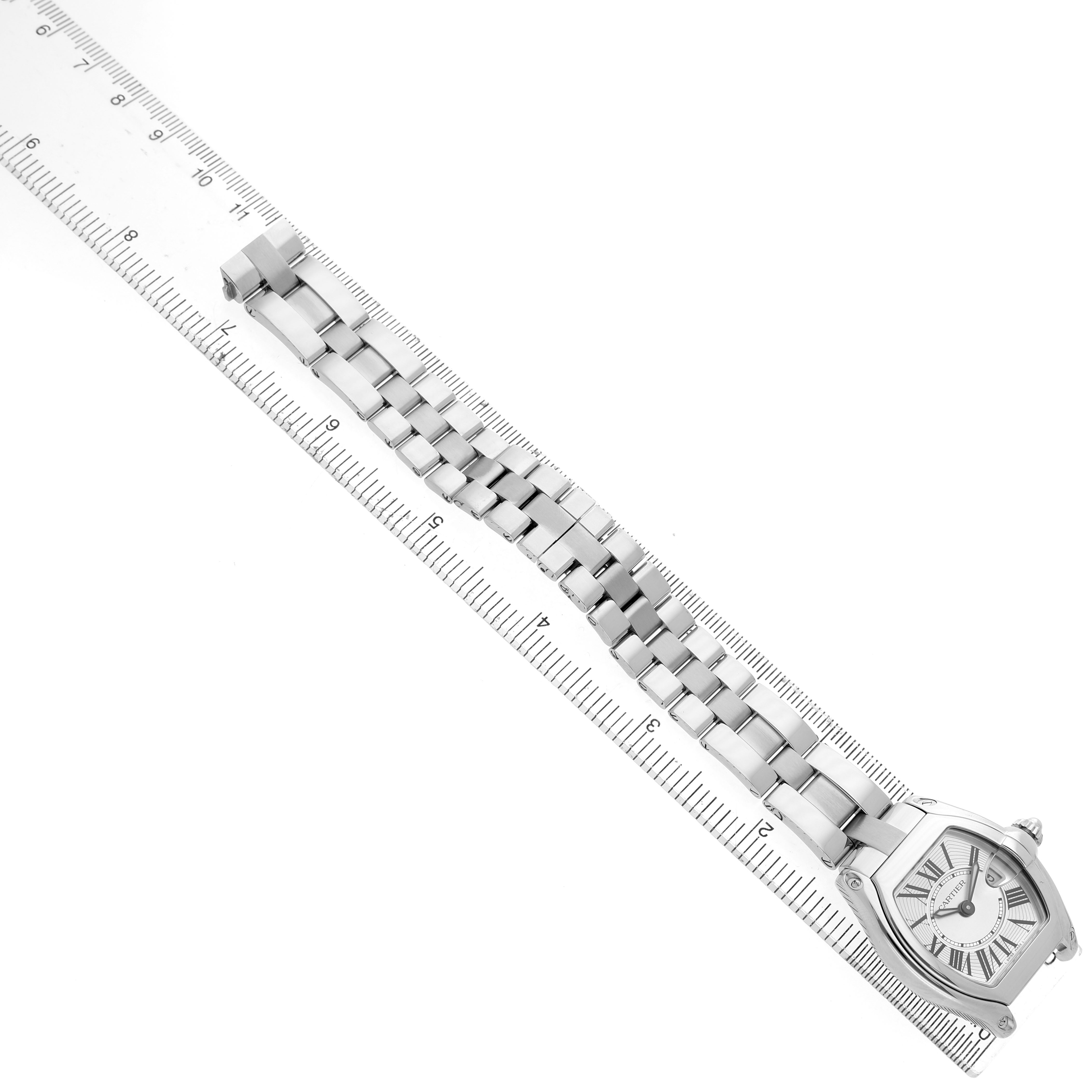 The Cartier Roadster W62016V3 Women's Stainless Steel Silver Dial watch is shown from a top view, displaying its full bracelet and case alongside a ruler for scale.