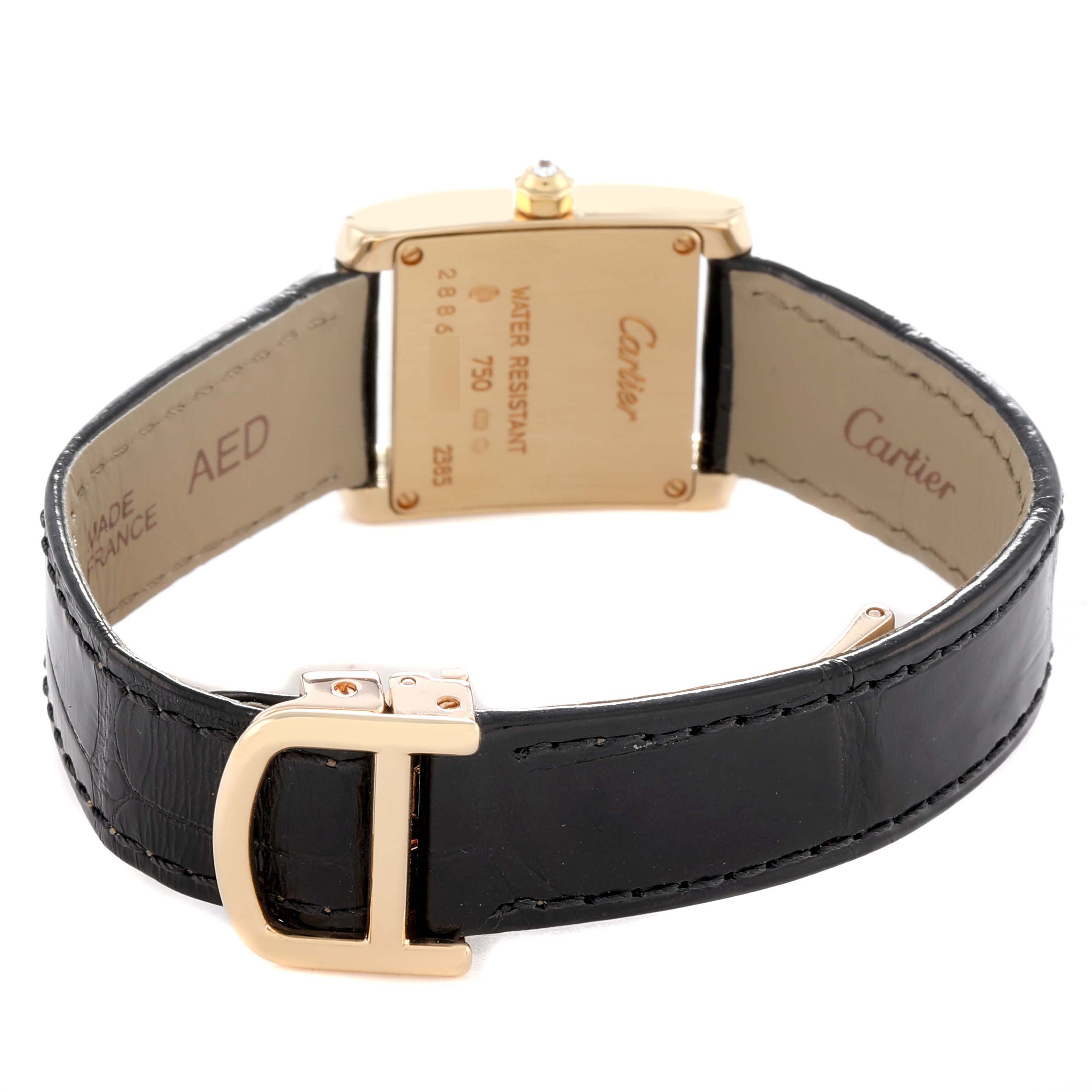 The Cartier Tank Francaise WE100151 Women's Yellow Gold Silver Dial is shown from the back, highlighting the clasp, case back, and leather strap interior.