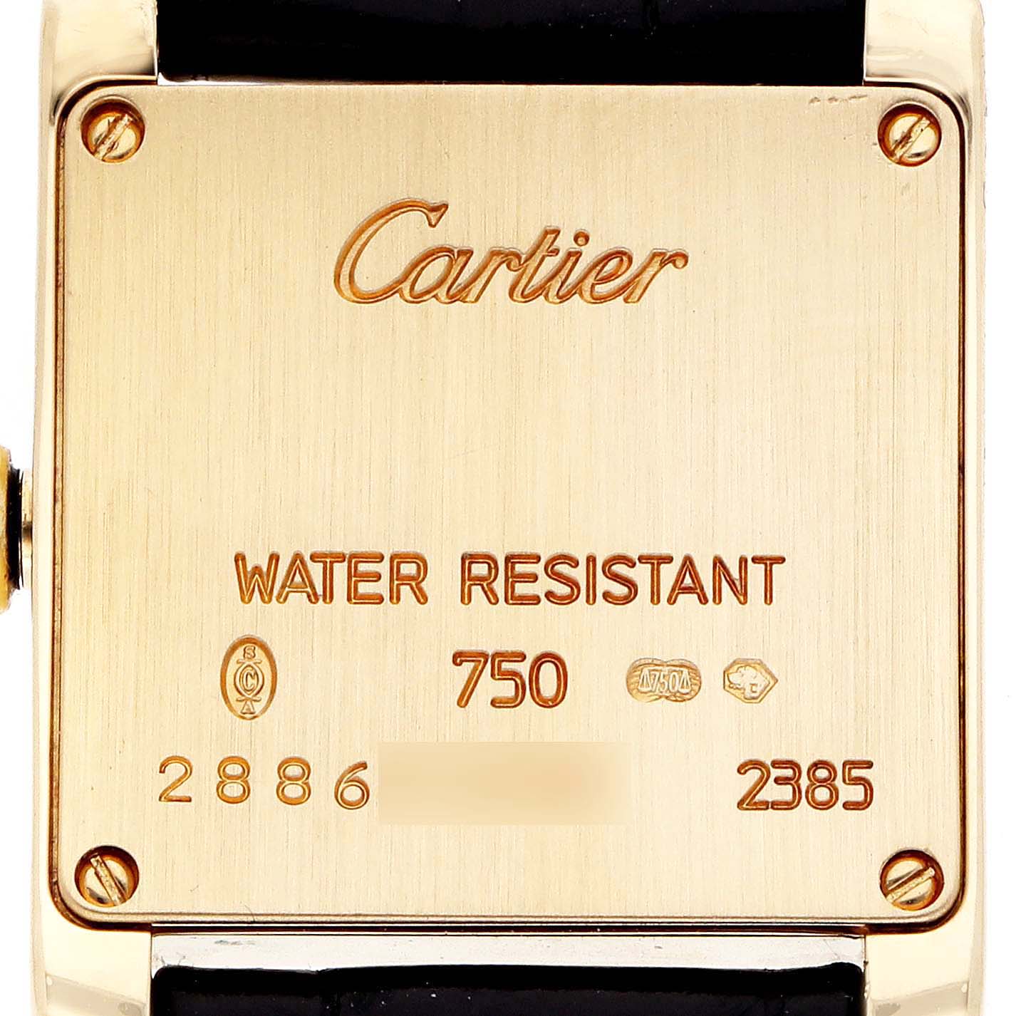 The image shows the back of a Cartier Tank Française watch, highlighting the engravings.