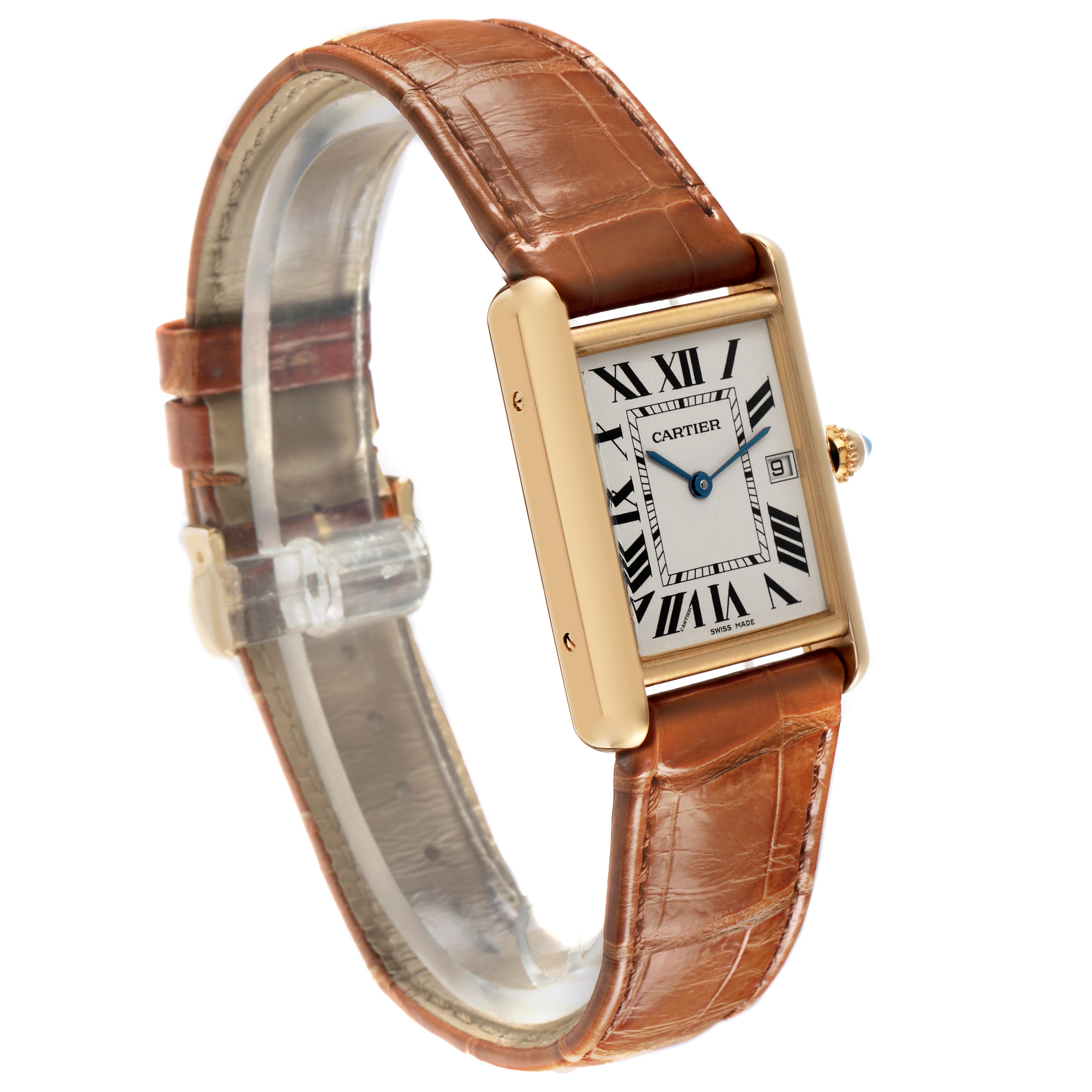 The Cartier Tank Louis W1529756 Men's Yellow Gold Silver Dial watch is shown at an angle displaying its face, gold case, brown leather strap, and crown with a blue gemstone.