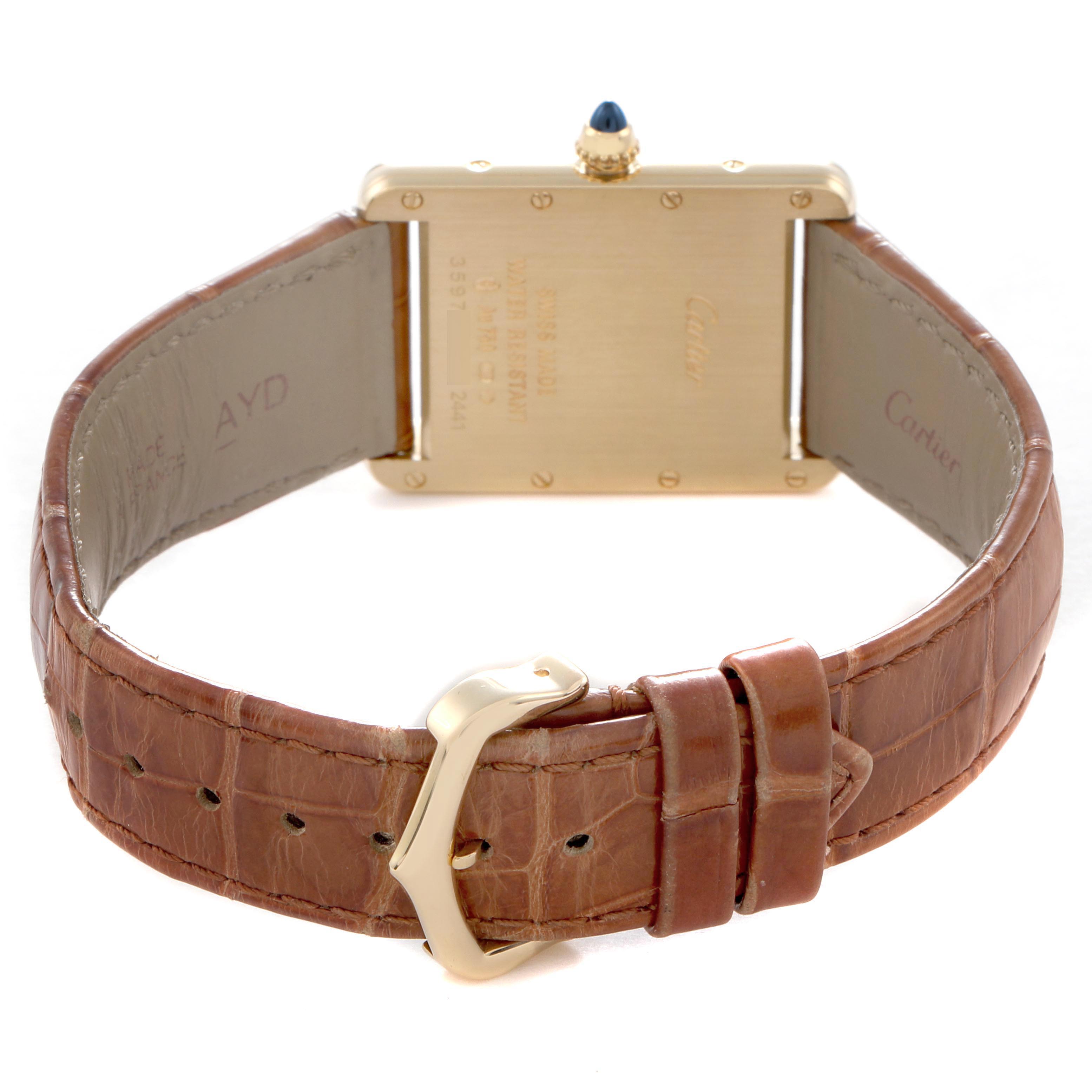 The image shows the backside of the Cartier Tank Louis W1529756 Men's Yellow Gold Silver Dial watch, displaying the case back, crown, and leather strap.