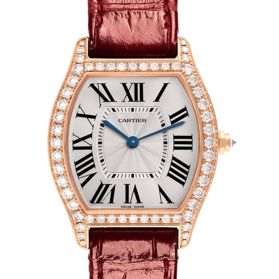 The Cartier Tortue watch is shown from the front, displaying its dial, Roman numerals, diamond bezel, and brown strap.