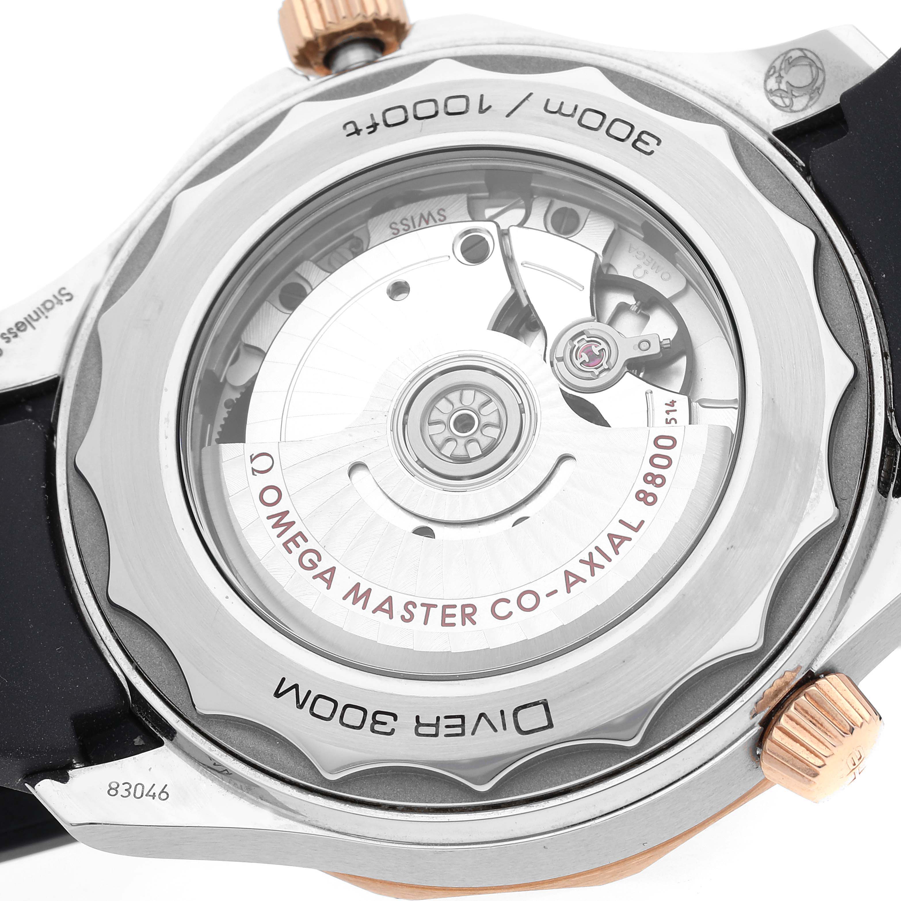The image shows the back view of the Omega Seamaster 210.22.42.20.01.002 Men's Steel and Gold (two tone) Black Dial watch, highlighting the visible movement and mechanism details.