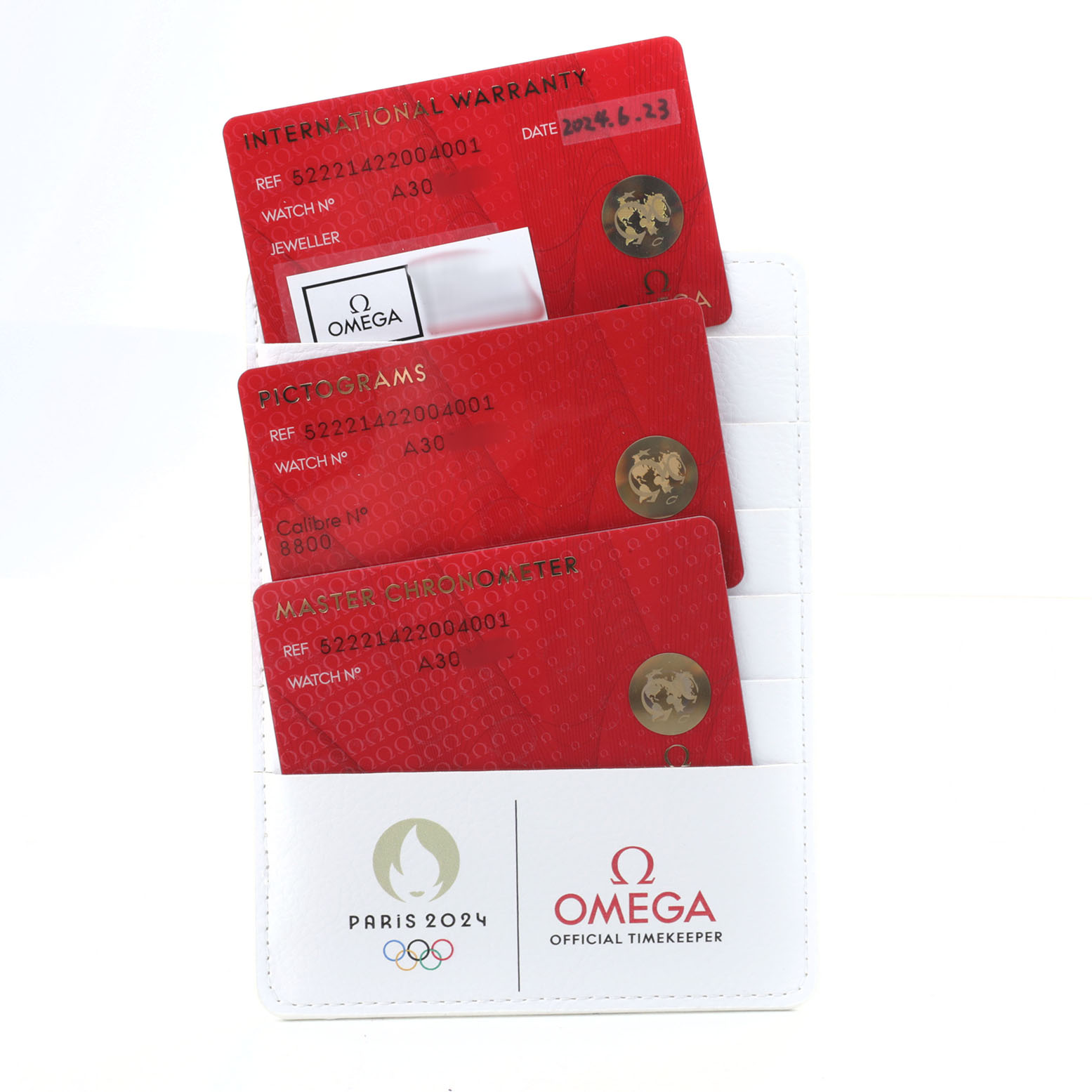 The image shows warranty and certification cards for an Omega Seamaster 522.21.42.20.04.001 Men's Steel and Gold (two tone) White Dial watch, displayed in a white cardholder.