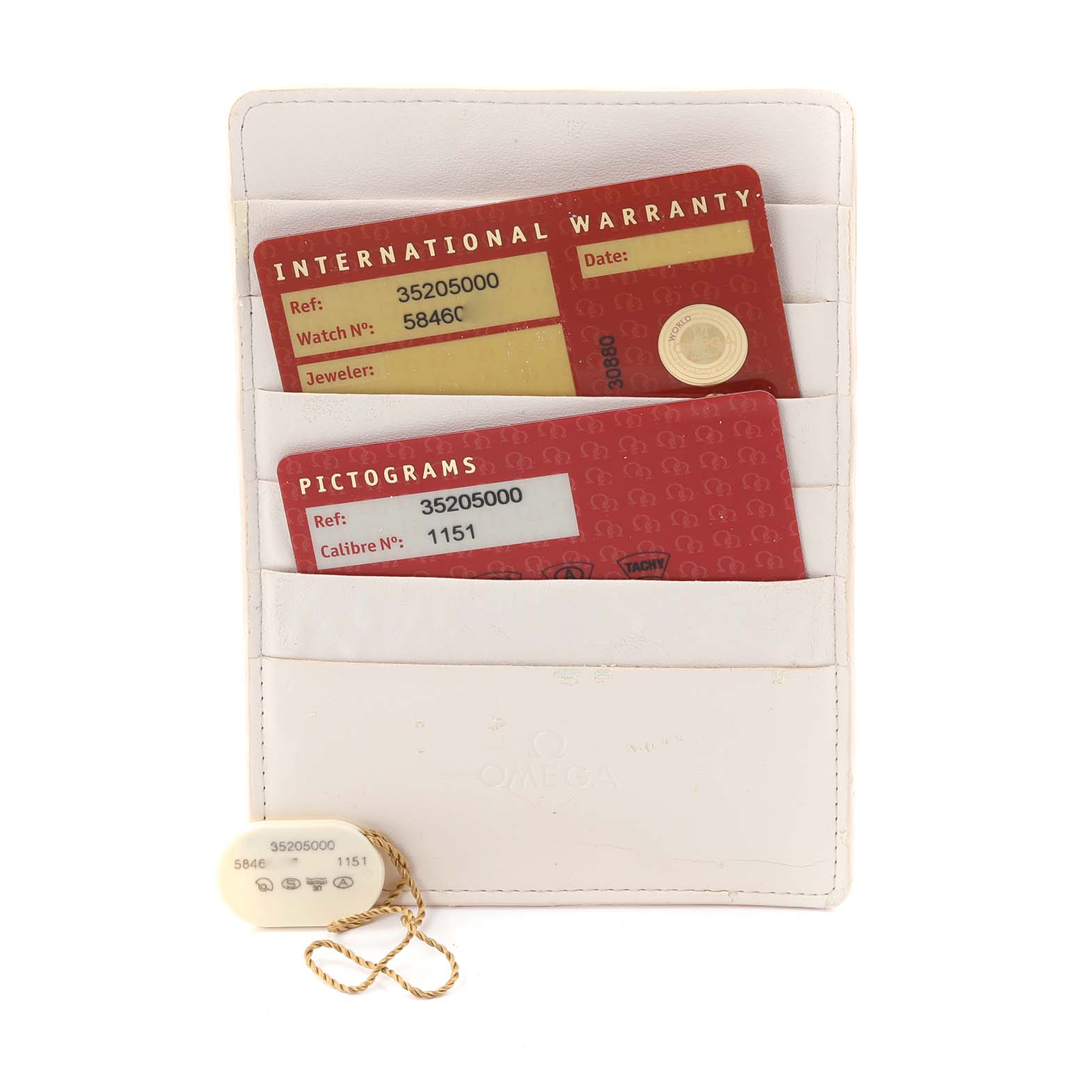 The image shows Omega Speedmaster 3520.50.00 Men
s Stainless Steel Black Dial 3520.50.00 Men
s Stainless Steel Black Dial warranty and pictogram cards in a white holder, along with a tag attached to a chain.