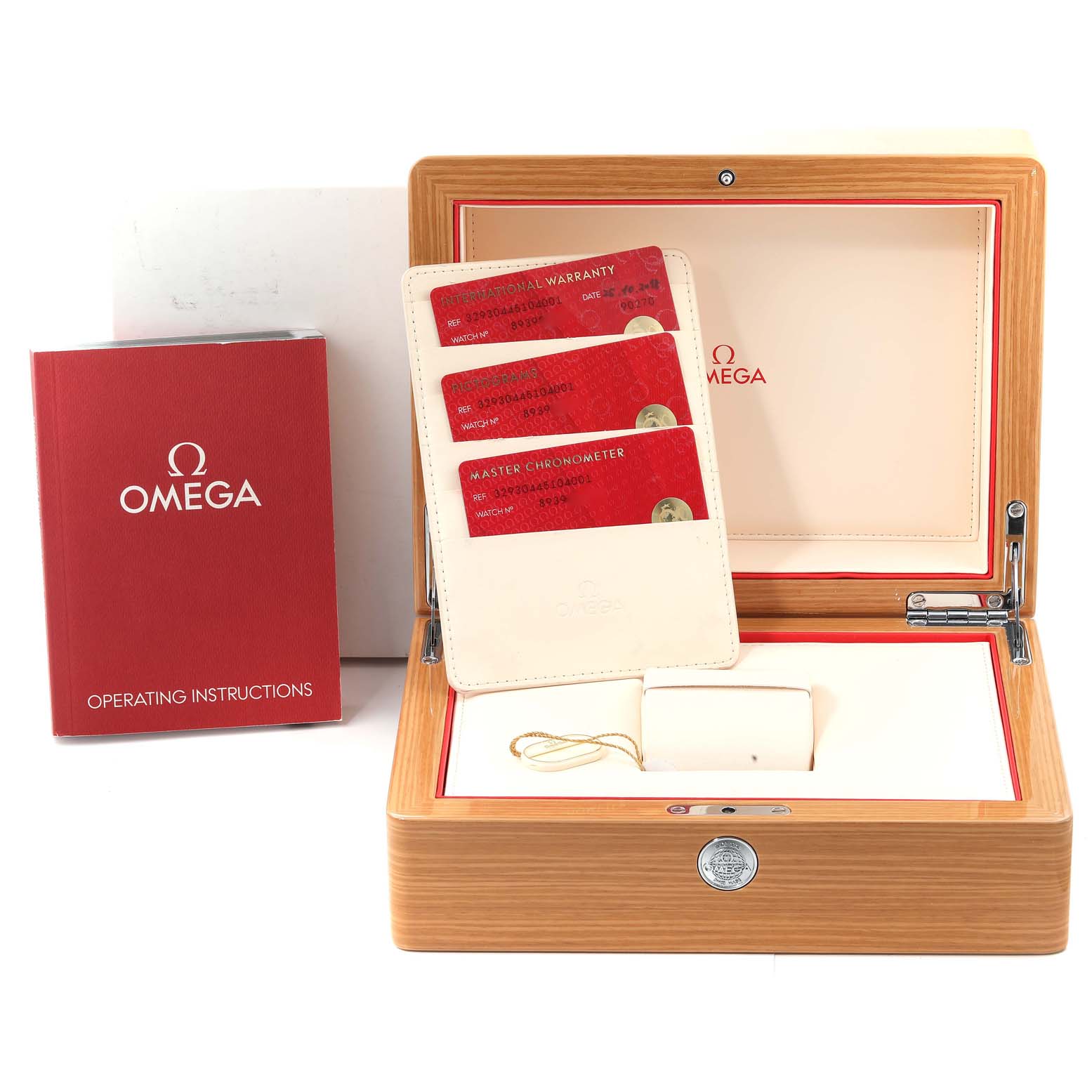 The image shows the Omega Speedmaster 329.30.44.51.04.001 Men's Stainless Steel Silver Dial accessories, including a wooden box, instruction manual, and warranty cards at a frontal angle.
