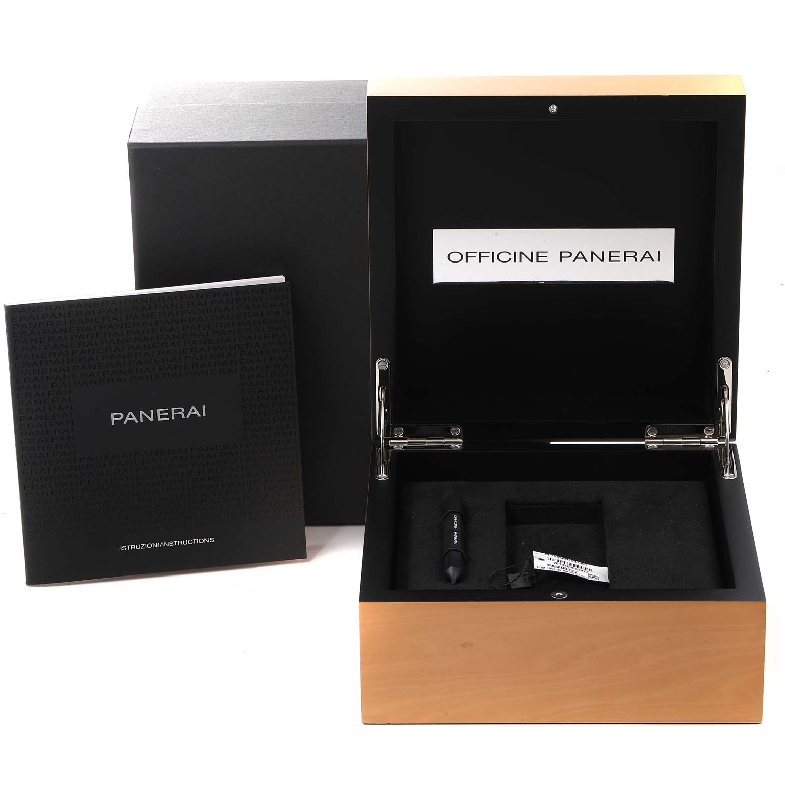 The image shows the open box of a Panerai Luminor PAM00722 Men
s Stainless Steel Black Dial PAM00722 Men
s Stainless Steel Black Dial watch, along with its instruction manual and included tool.
