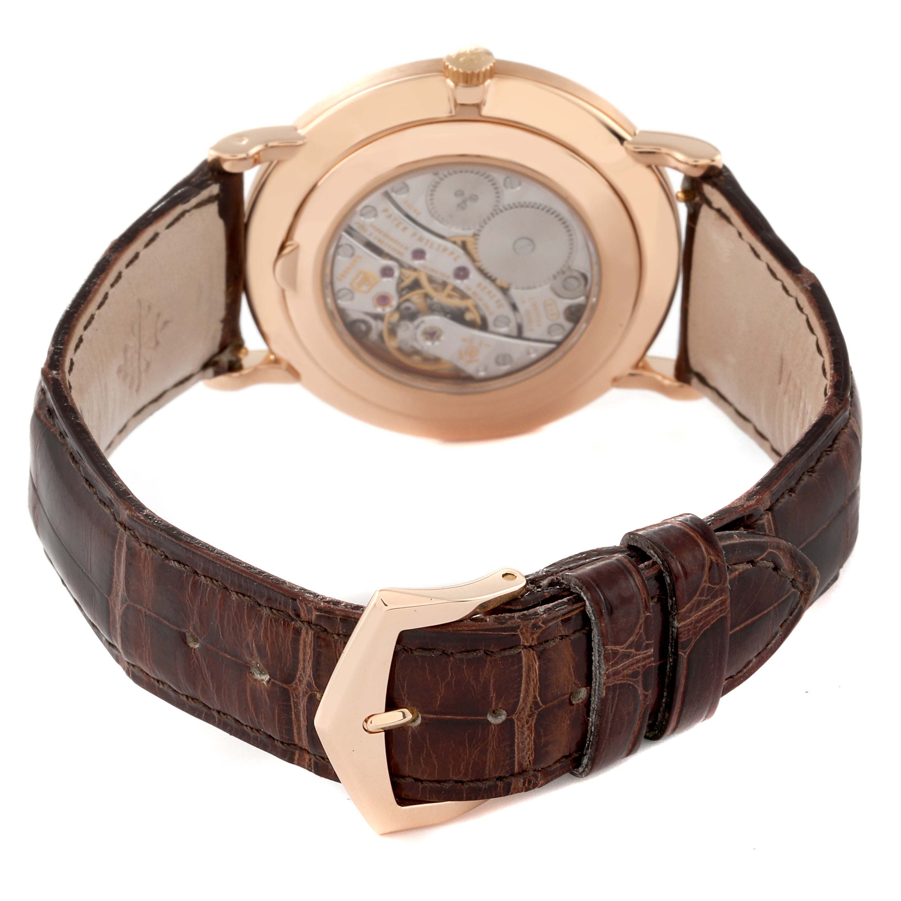 This image shows the back view of a Patek Philippe Calatrava 5119R Men
s Rose Gold White Dial 5119R Men
s Rose Gold White Dial watch, highlighting its movement and leather strap with buckle.