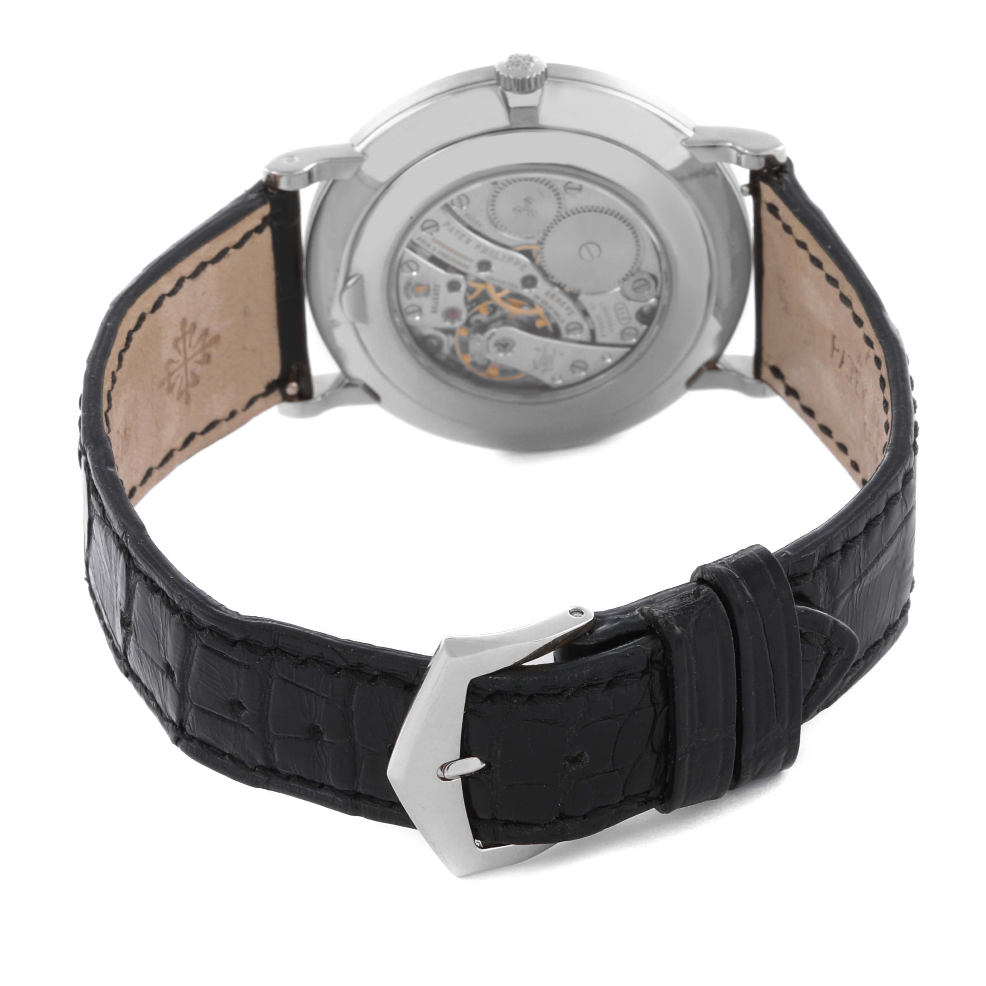 The image shows a Patek Philippe Calatrava 5116G Men
s White Gold White Dial 5116G Men
s White Gold White Dial watch from the back, highlighting its movement and black leather strap.