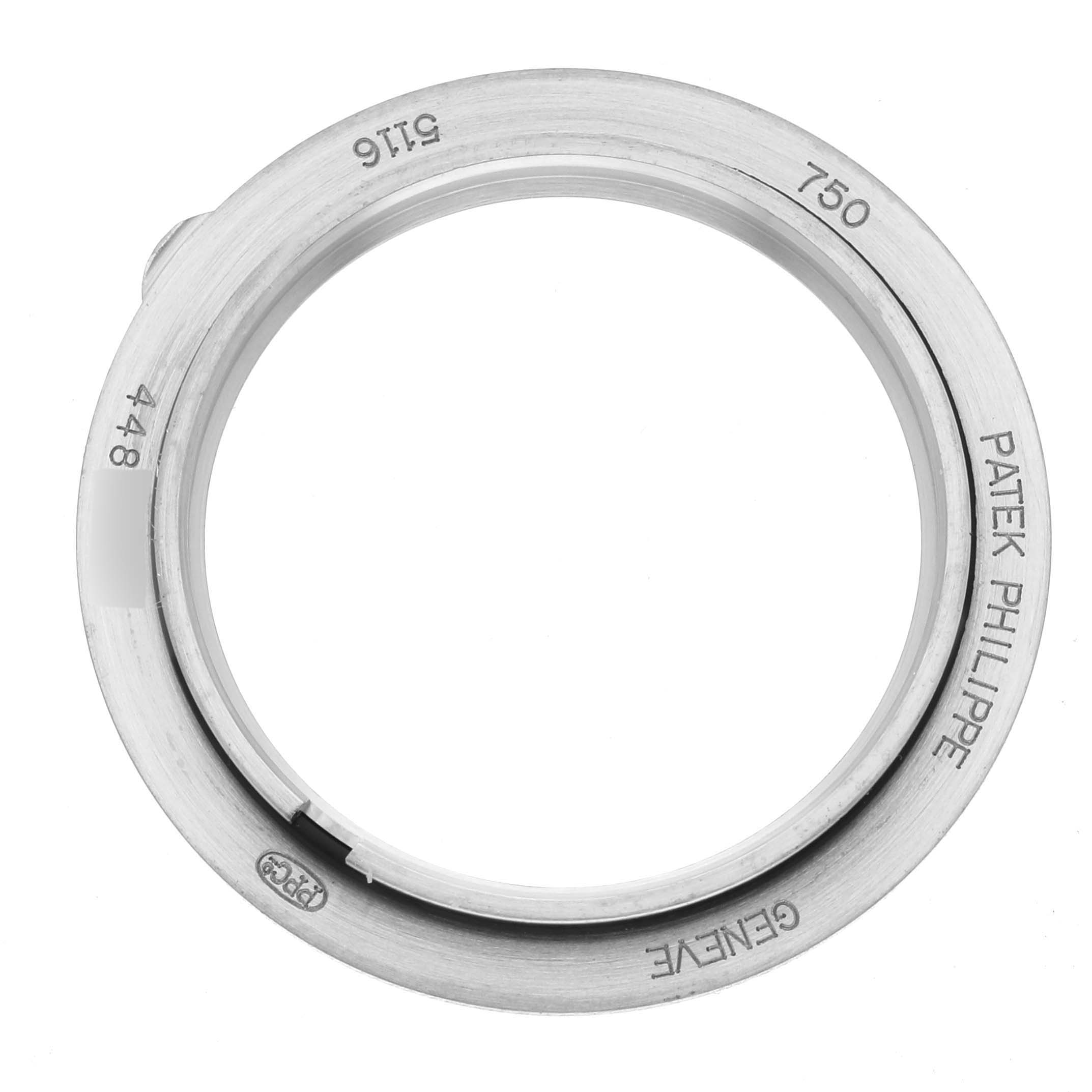 The image shows a top view of a Patek Philippe Calatrava 5116G Men
s White Gold White Dial 5116G Men
s White Gold White Dial watch bezel, displaying engravings and hallmark details.