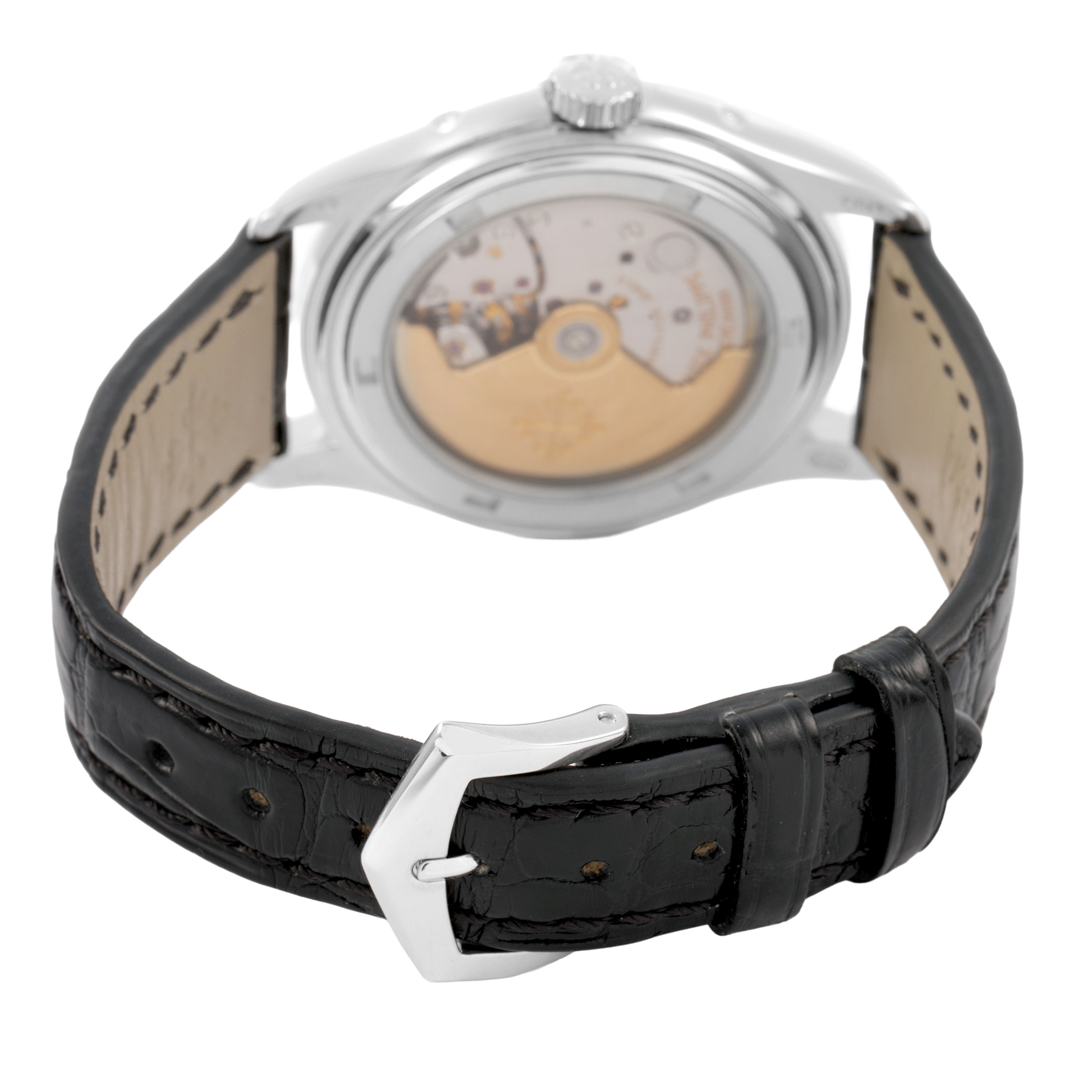 The image shows the back of the Patek Philippe Complications 5035G-039 Men's White Gold Silver Dial watch, highlighting the transparent case back and leather strap with buckle.