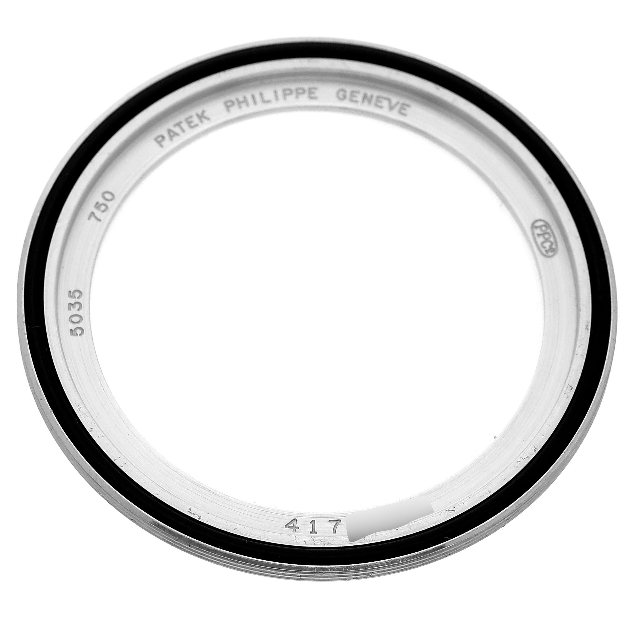 The image shows a top-down view of a bezel for a Patek Philippe Complications 5035G-039 Men's White Gold Silver Dial model, featuring engravings.