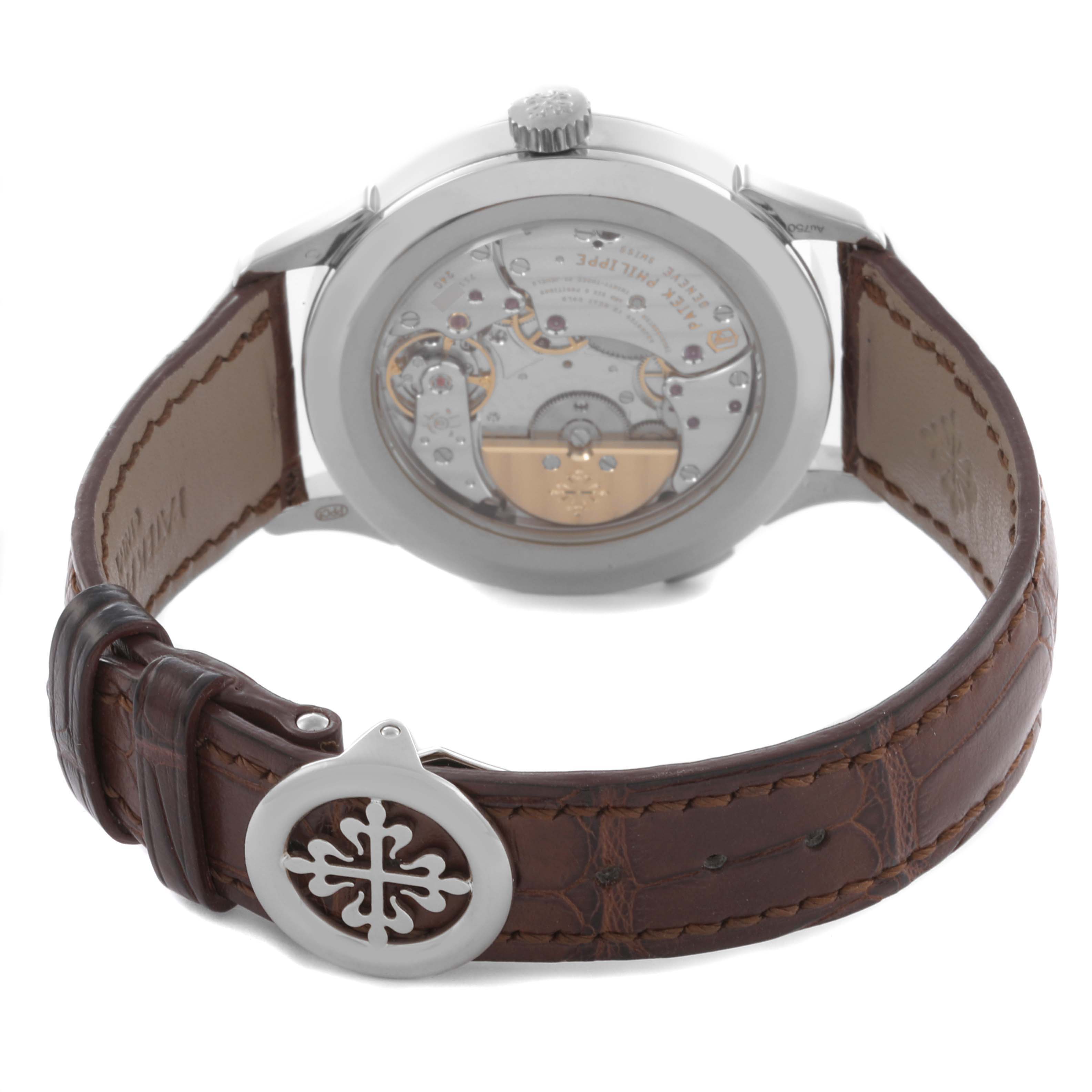 The Patek Philippe Complications 5230G-001 Men's White Gold Silver Dial 5230G-001 Men's White Gold Silver Dial watch is shown from the back, highlighting the movement and leather strap.