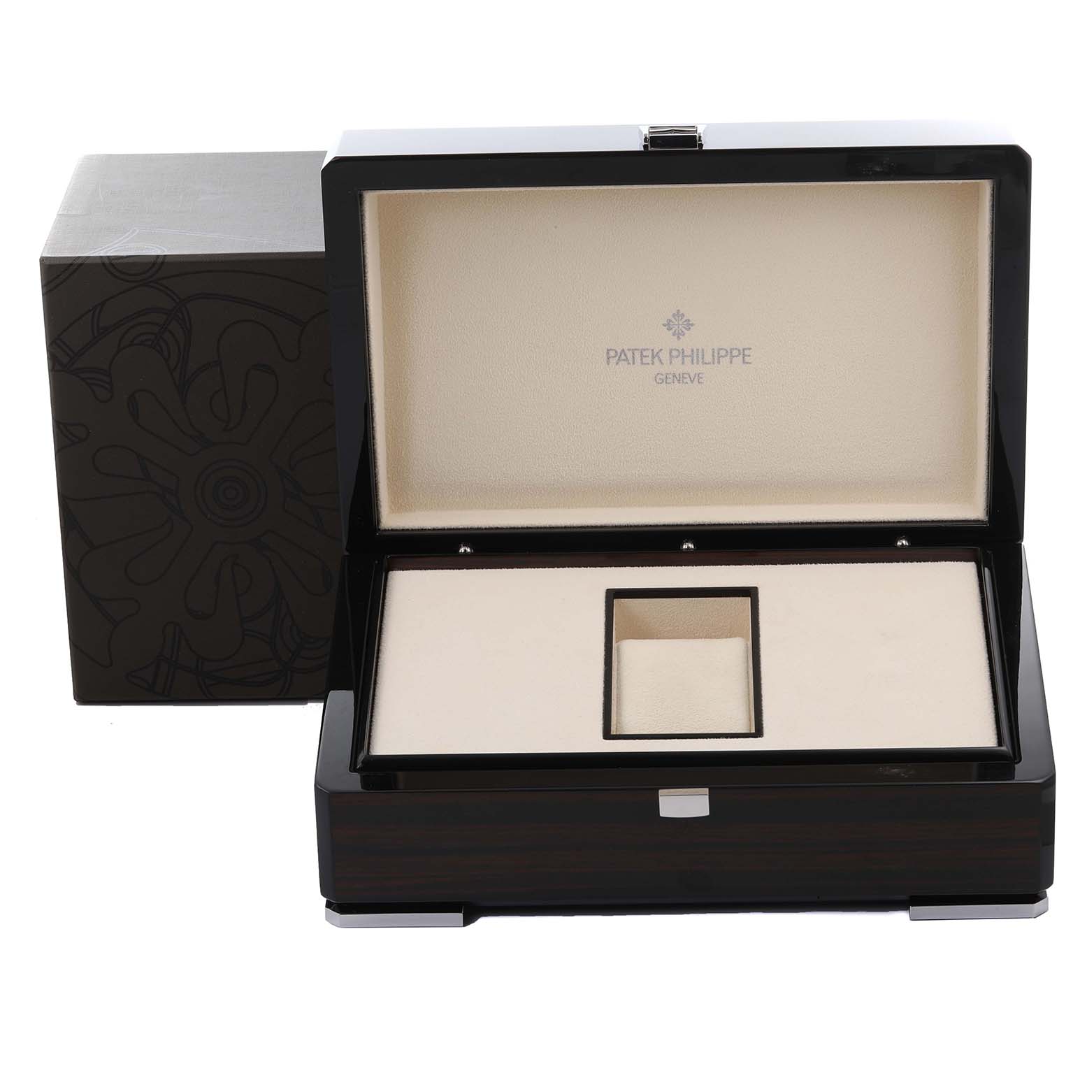 The image shows an open watch box for a Patek Philippe Complications 5230G-001 Men's White Gold Silver Dial 5230G-001 Men's White Gold Silver Dial model, revealing its interior and exterior design.