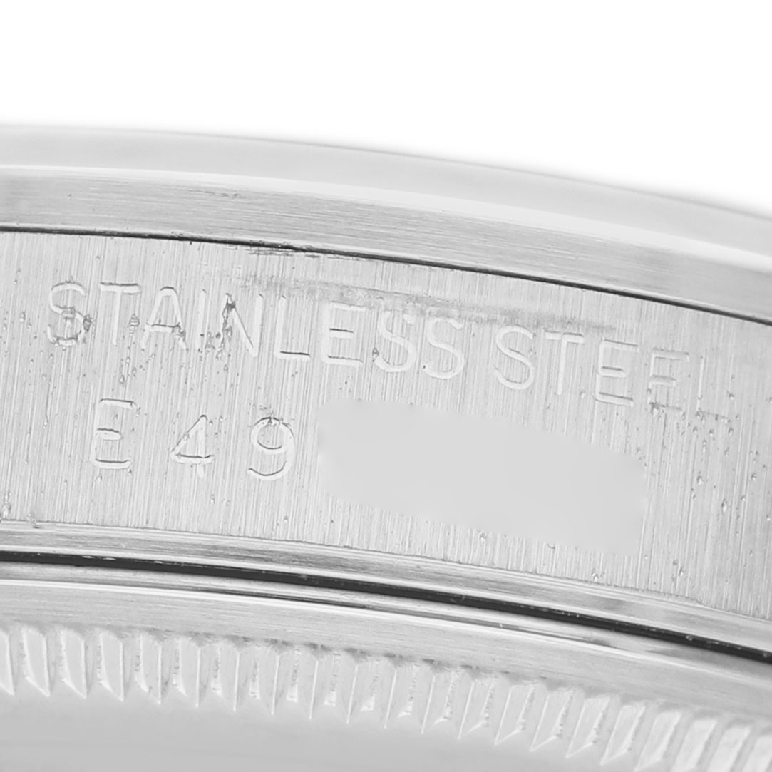 The image shows a close-up of the Rolex Air-King 14000 Men's Stainless Steel Silver Dial model's stainless steel case edge, featuring engraved text.