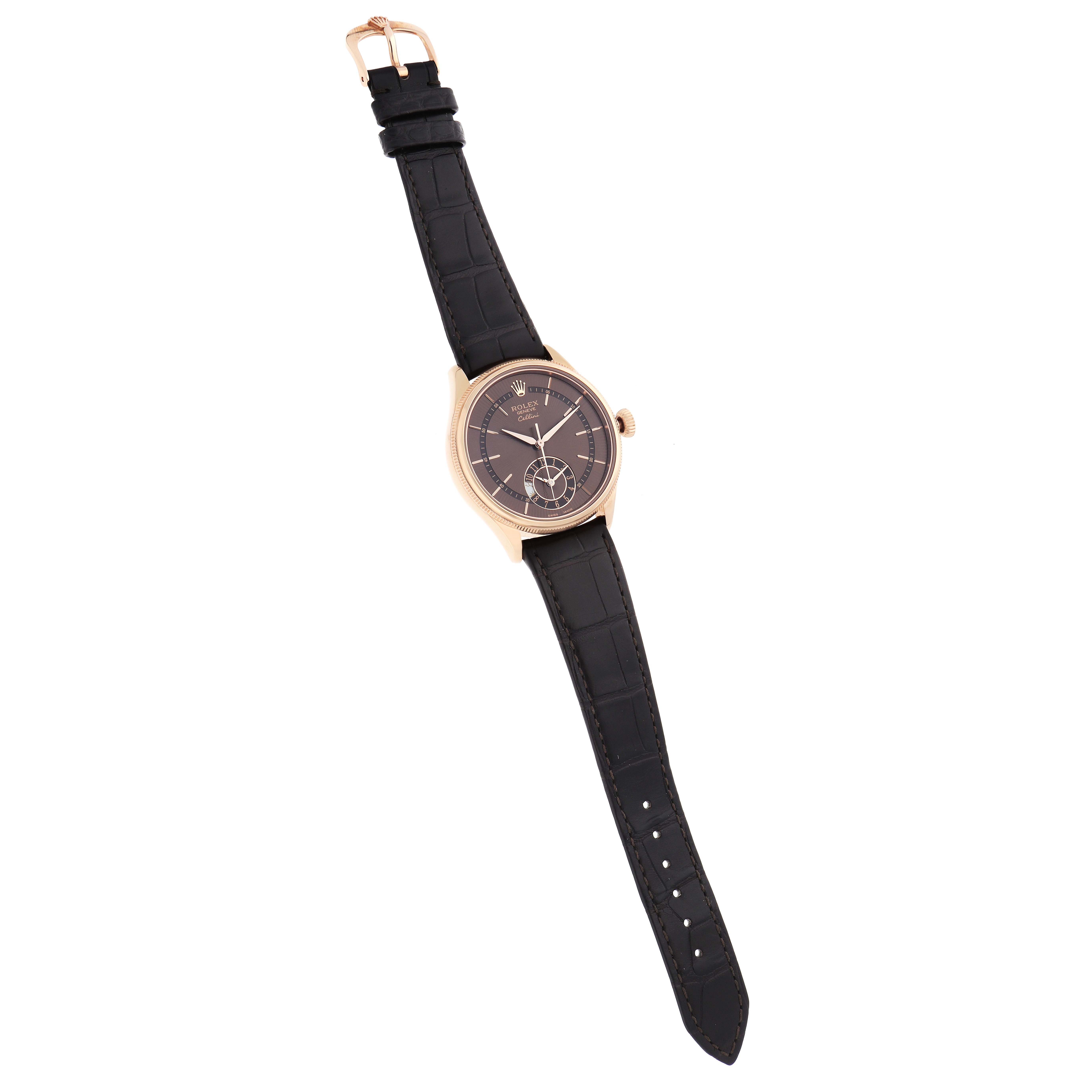 The Rolex Cellini 50525 Men's Rose Gold Brown Dial watch is shown from a top-down angle, displaying the face, bezel, and leather strap.
