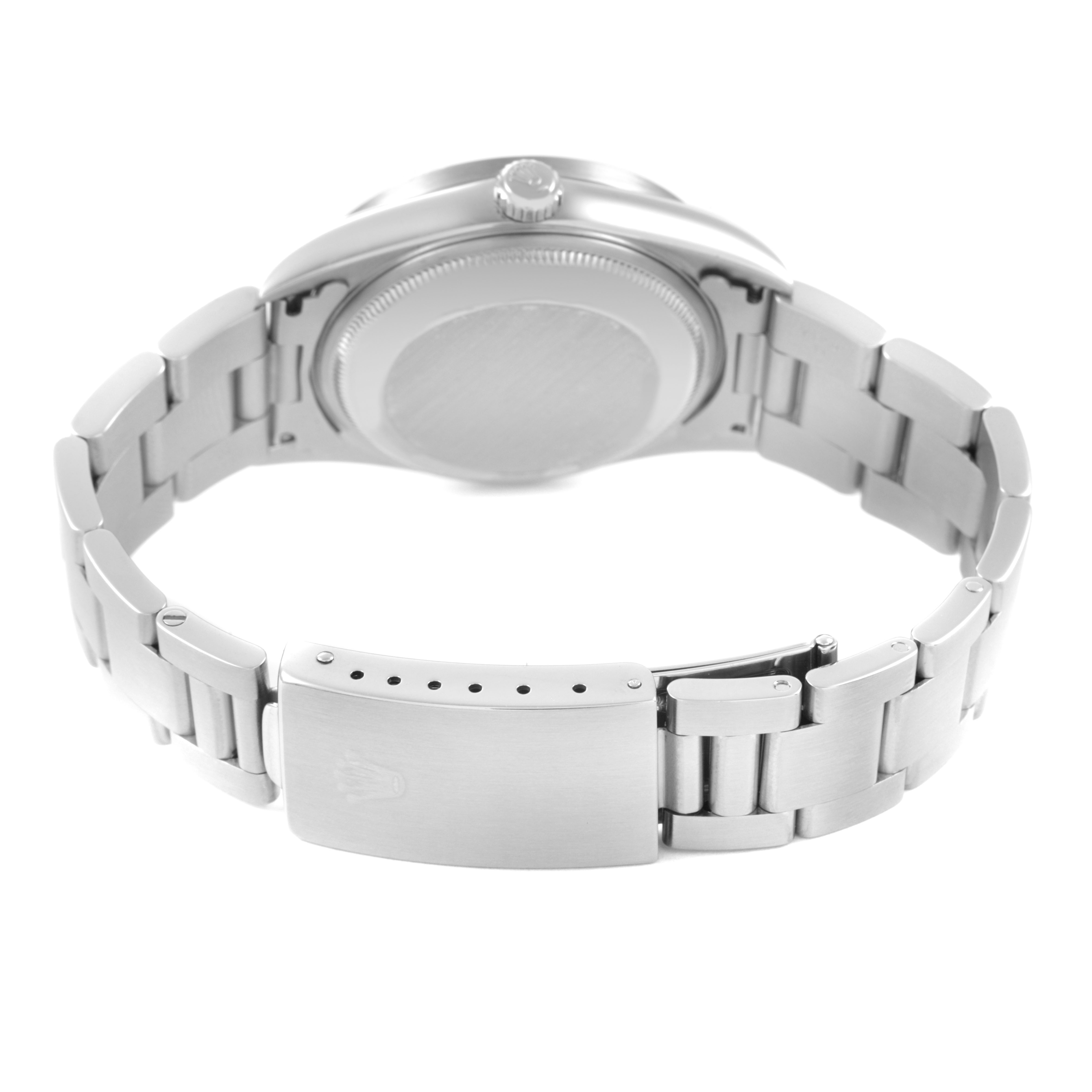 The image shows a Rolex Date 15210 Men's Stainless Steel Black Dial model watch from the back, highlighting the bracelet, clasp, and case back.