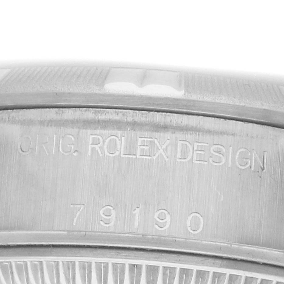 The image shows the side of a Rolex Date 79190 Women's Stainless Steel Pink Dial model, featuring an engraved design and model number.